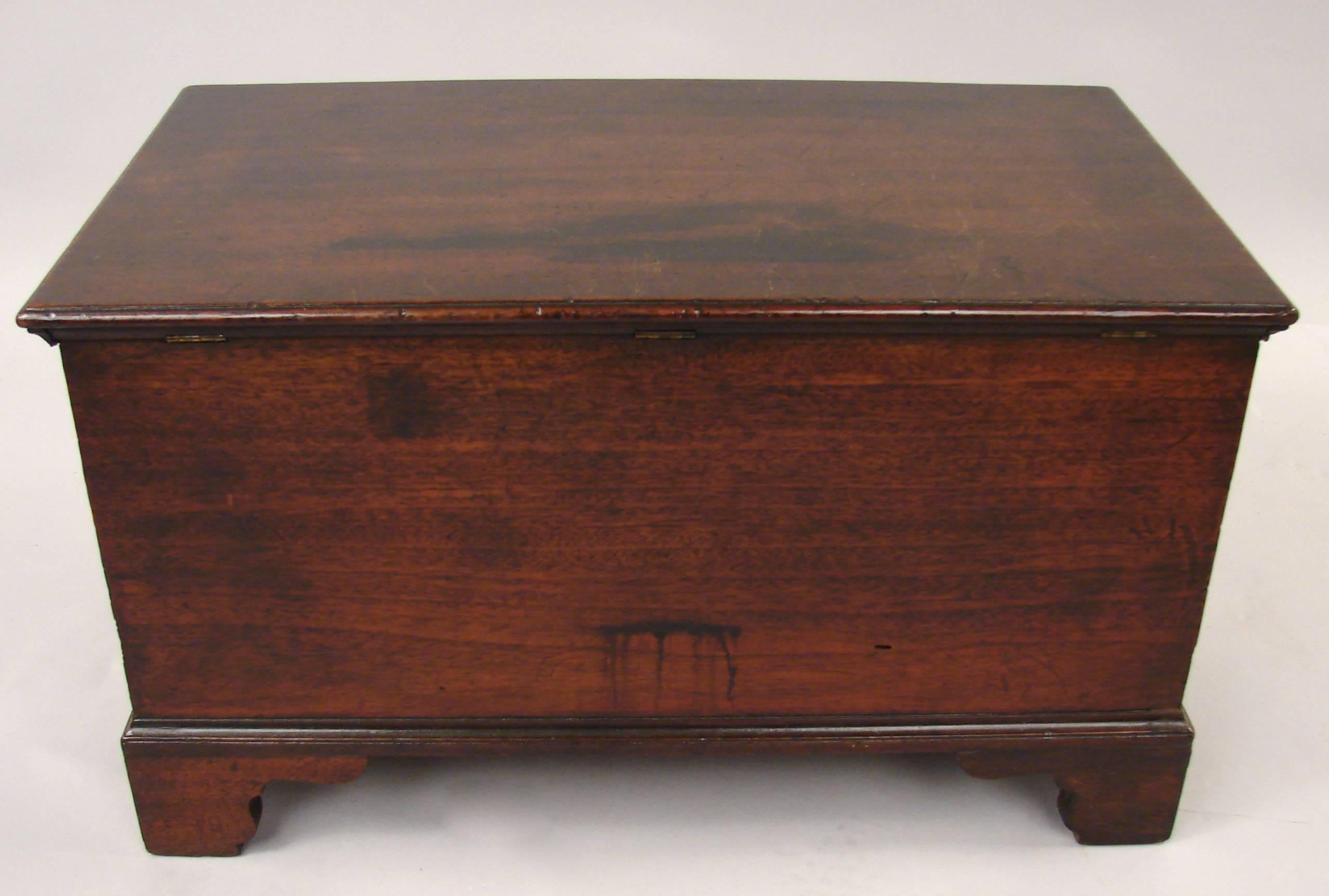 An unusual George III mahogany small chest on bracket feet, the hinged lid opening to an elaborately fitted interior with multiple drawers and sliding sections. Excellent color.