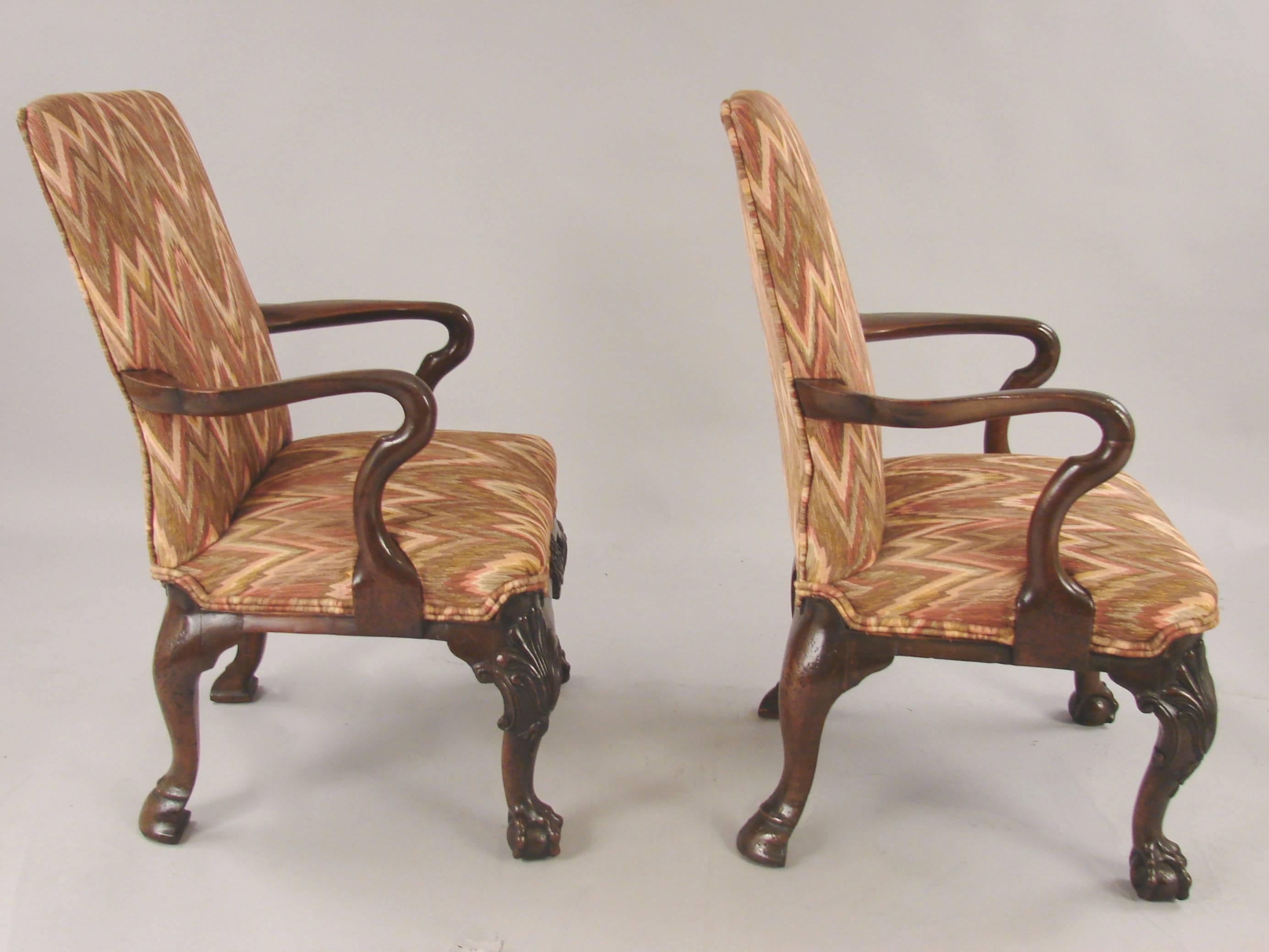 A fine pair of English George II style mahogany child's chairs now covered in flame stitch upholstery. These child's chairs are beautifully carved with lovely shell apron, carved knees and ball and claw feet, circa 1840-1860.