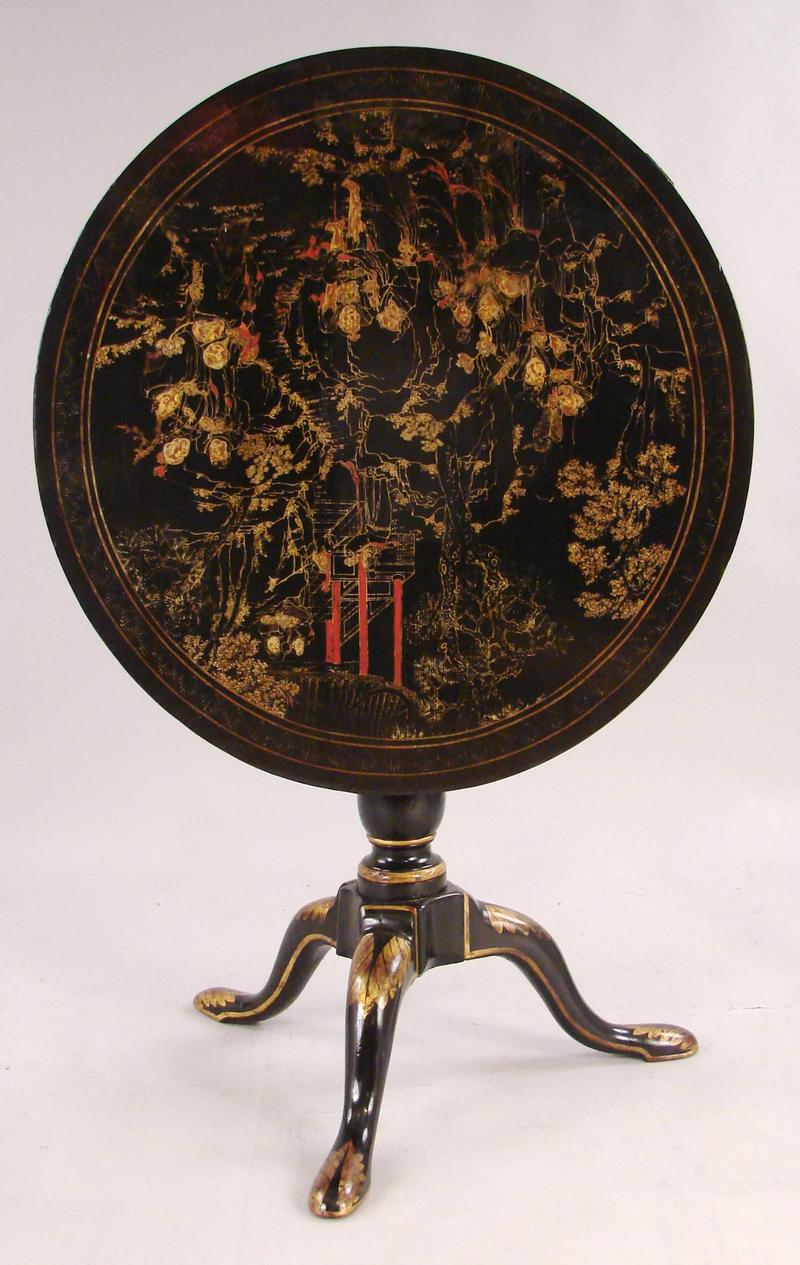 A George III style black lacquer and gilt tilt-top table with a turned columnar support on tripod base ending in pad feet, circa 1800-1820. Decoration of a later date.