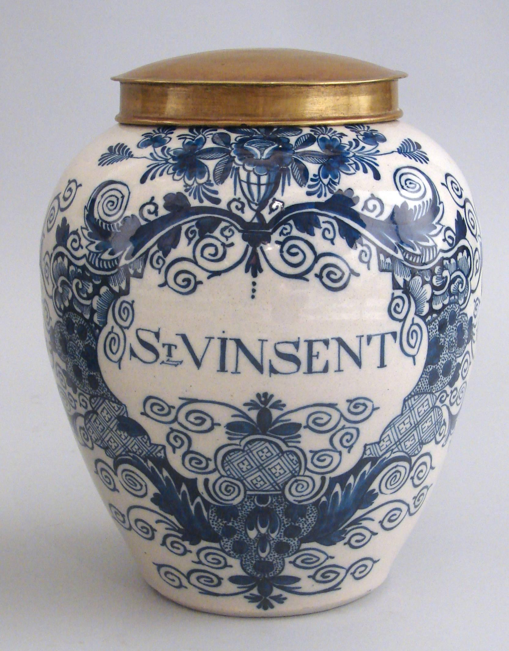 A pair of antique blue and white Dutch Delft tobacco jars of typical form with stylized floral decoration, one marked 