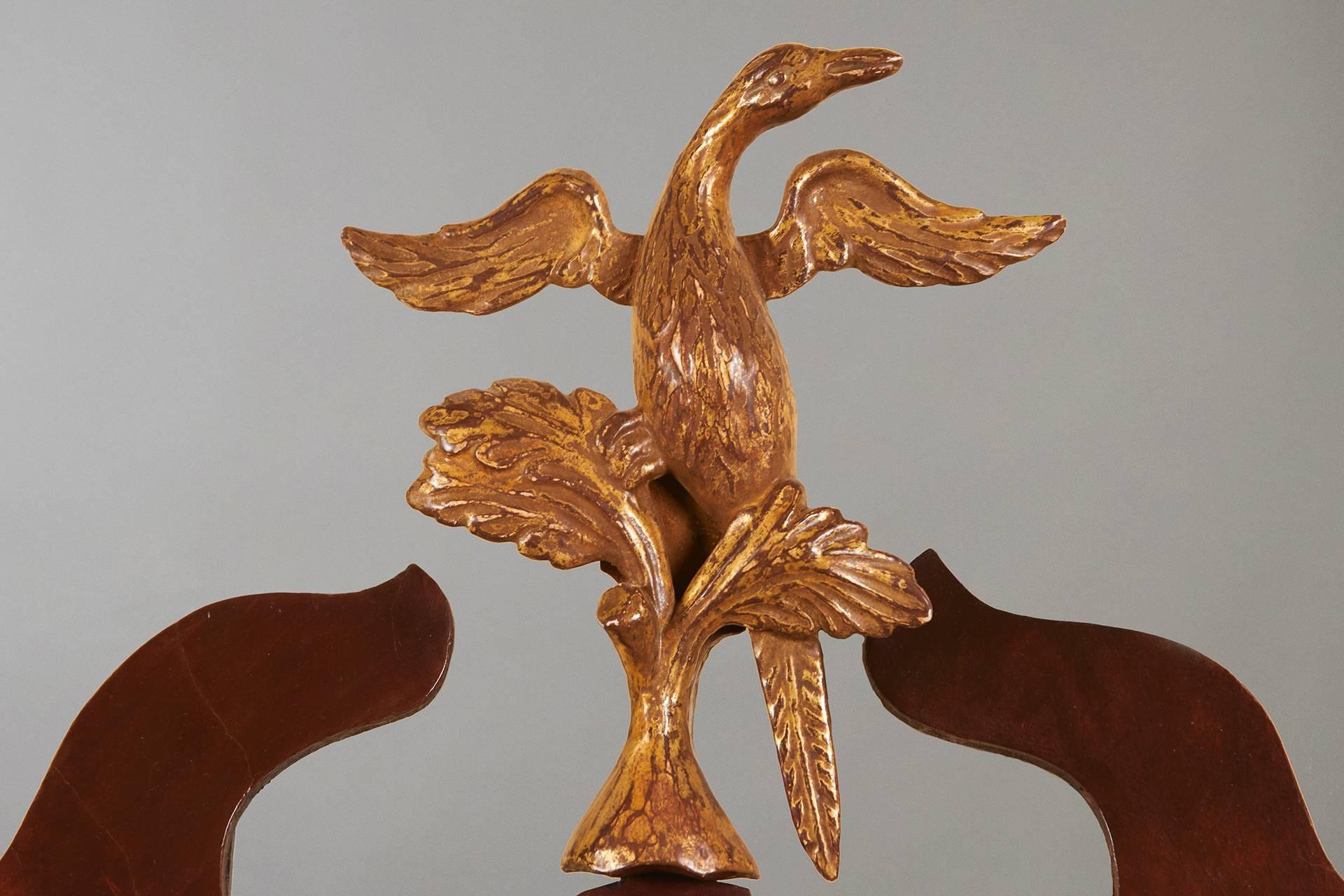 A pair of English mahogany parcel-gilt Chippendale mirrors each with gilt eagle cresting, liners and foliate edges appearing to retain their original glass plates, circa 1770.