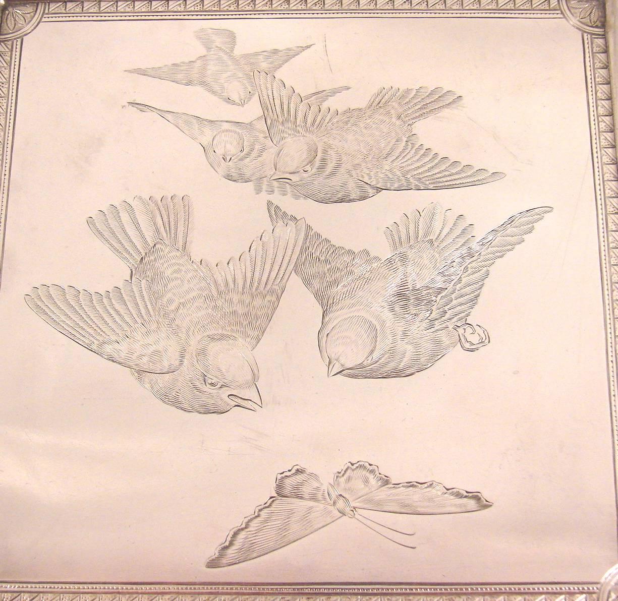 An American sterling silver engraved tray depicting birds and a butterfly in flight with a gadrooned border made by the Frank Whiting Company, impressed on reverse with the Whiting hallmark stamped sterling. Monogrammed on back in script A.H.T. from