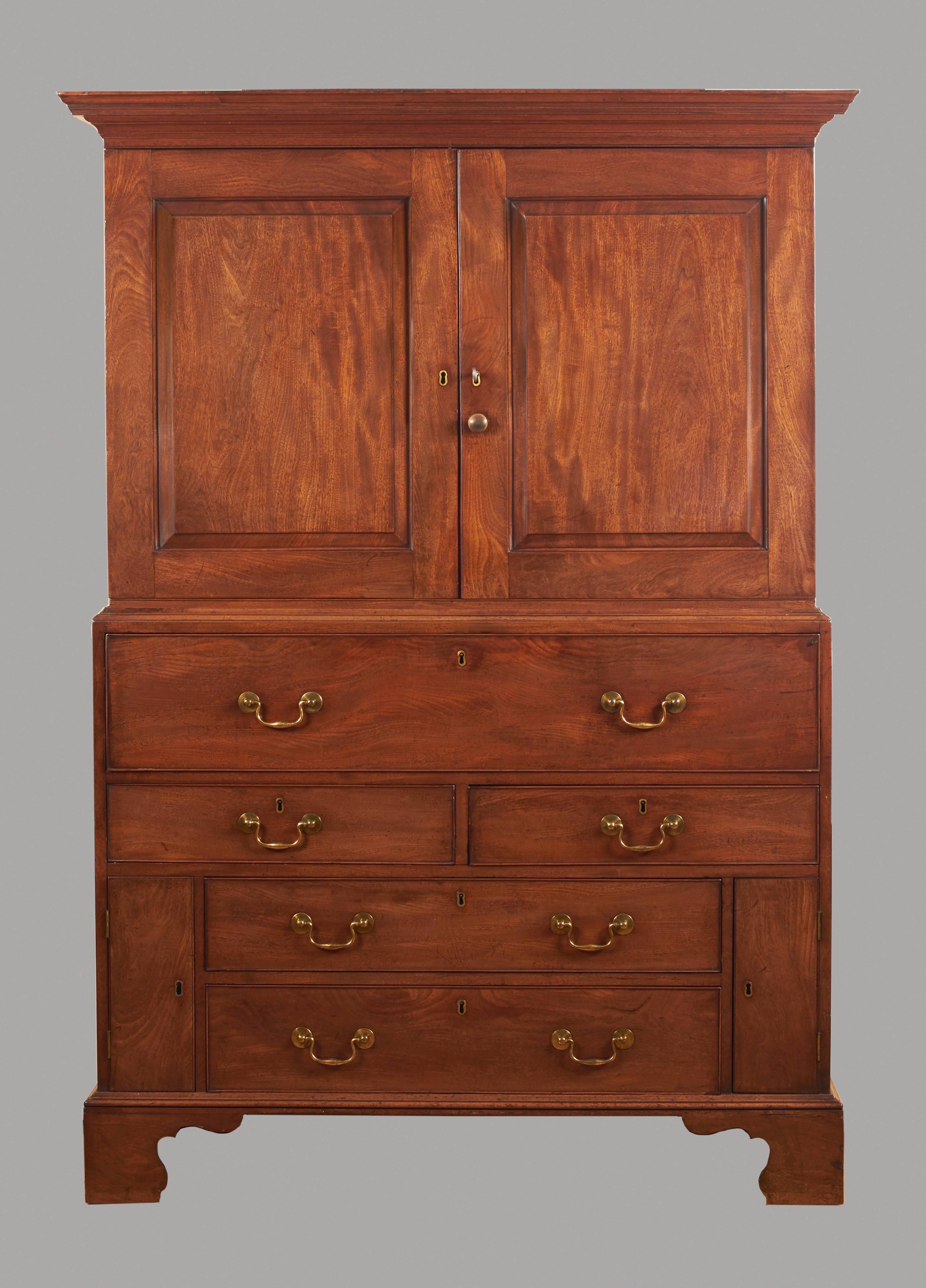 A fine quality George III period secretaire cabinet, the upper stage with paneled cupboard doors opening to reveal a single shelf above two drawers, the lower portion with a well-fitted secretaire interior with eight small drawers and a prospect