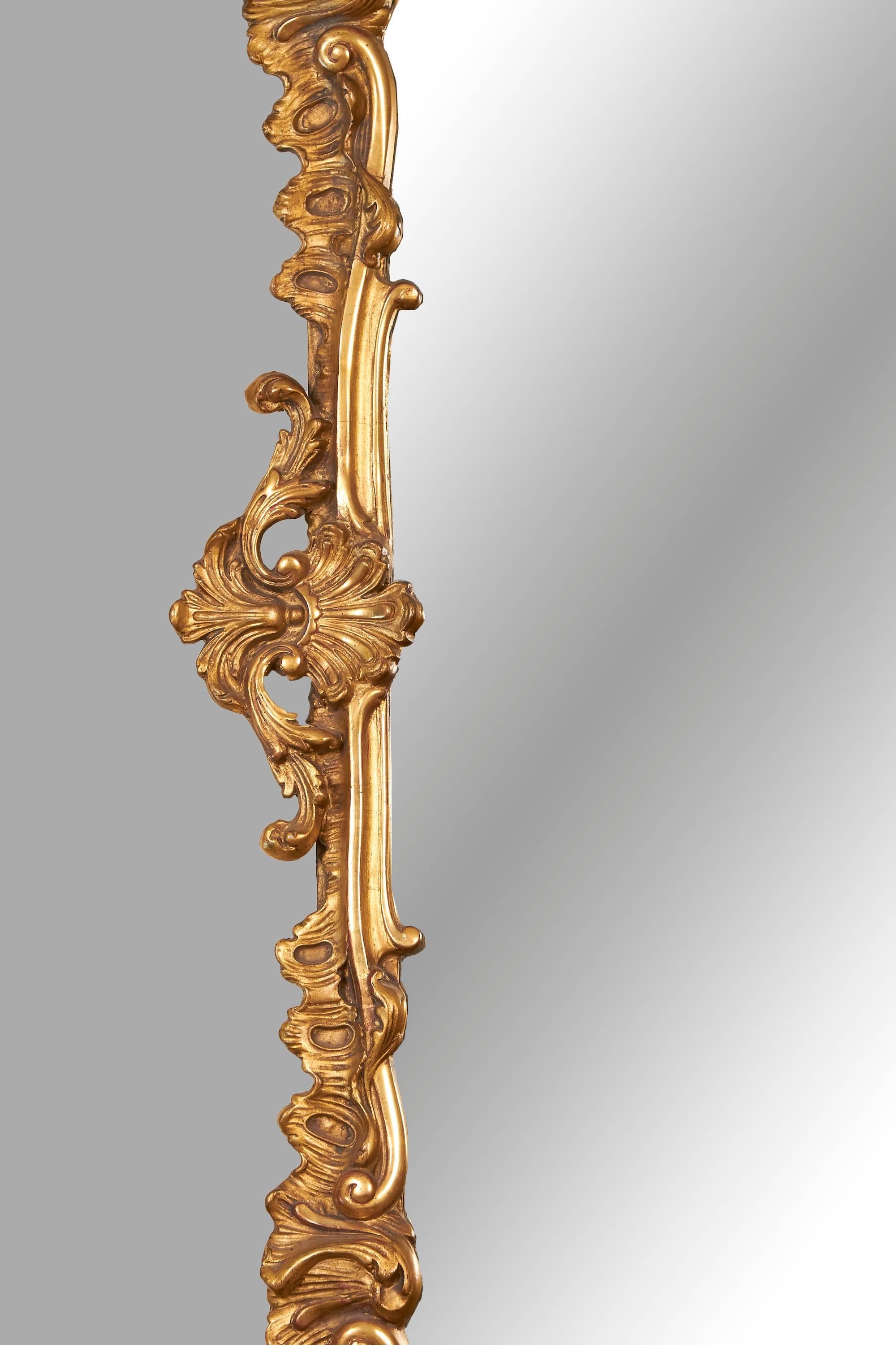 A Louis XV style giltwood and gilt composition mirror with overall foliate decoration, the lower corners decorated with shell motifs, the mirror plate apparently original, circa 1880.