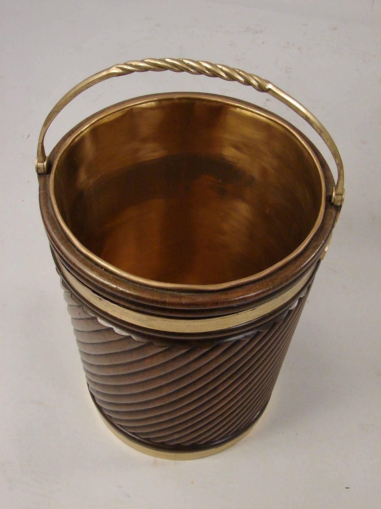 An attractive pair of handmade large-scale English or Irish mahogany Georgian style peat buckets with liners, each with rope carved bodies and twist brass handles.