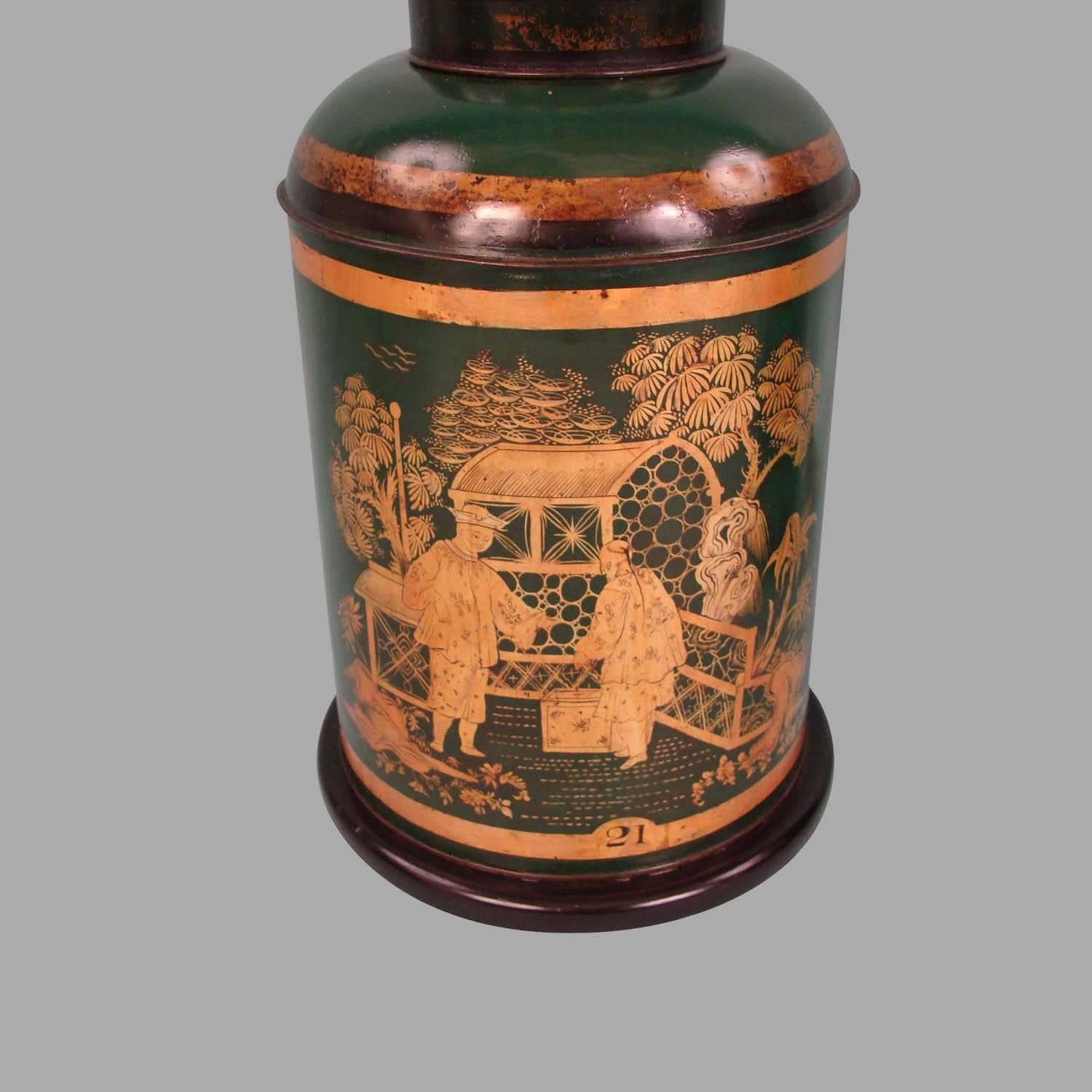 A well-decorated pair of 19th century Chinese export dark green and gold decorated tea canisters depicting figures in a garden setting, one marked 12 the other 21. Now electrified with wooden bases and fitted as lamps. Decoration refreshed.