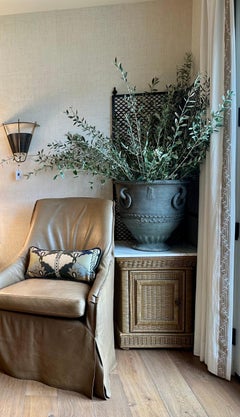 Pair of taupe leather, skirted slip-covered Verellen chairs on casters