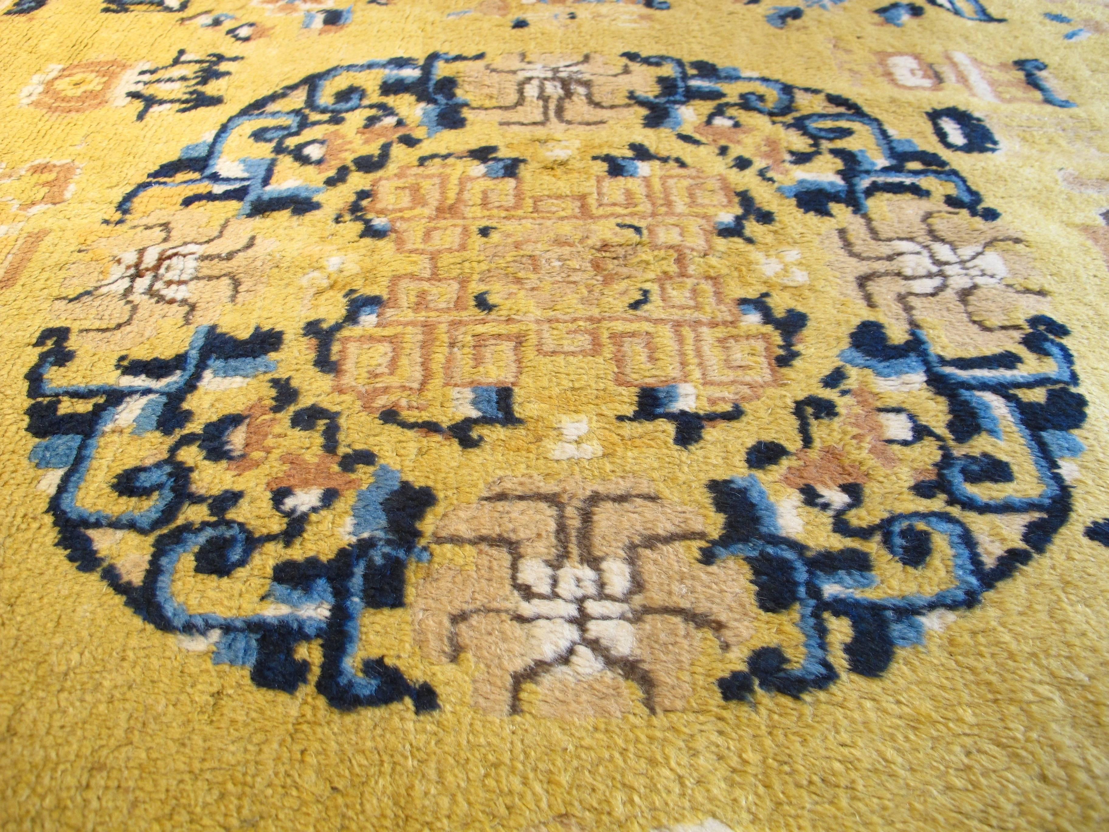 This elegant Chinese long carpet or 'kang' integrates a traditional medallion and corner-pieces design with a host of decorative elements that give the field more of an all-over feel. Roundels traced in open-work and floral garlands form a so-called