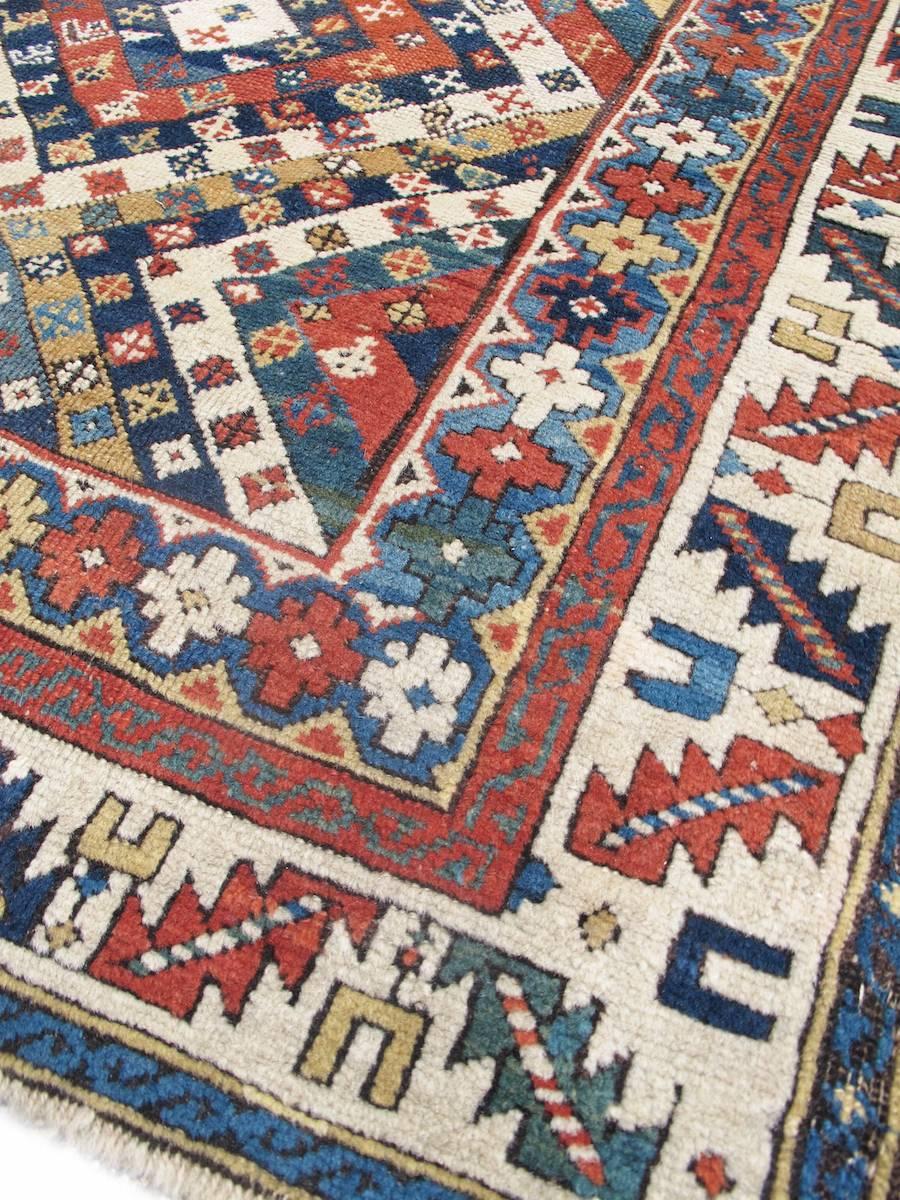 Caucasian rugs are often known for their graphic boldness and color contrast. This graphically sophisticated Kuba presents a highly successful visual alternative to the usual large-scale ornament and open spacing expected with many of the weavings