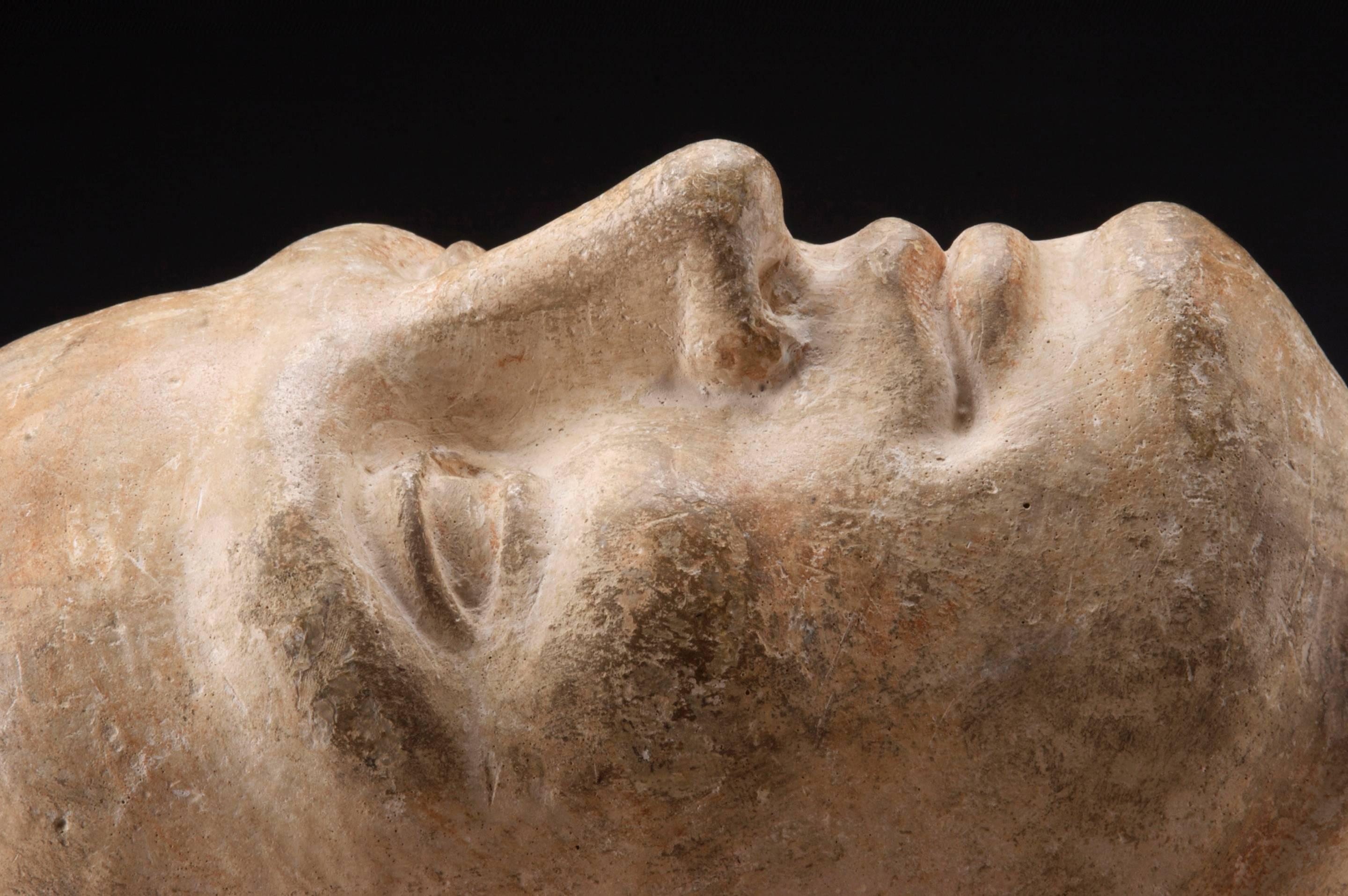 An fine sculpture of a young man who appears lost in a dream. Finely modeled with a placid expression and incised, upright hair. Inscribed on the neck: S. Bertran  On a later pillow base.  Mid 20th Century.
