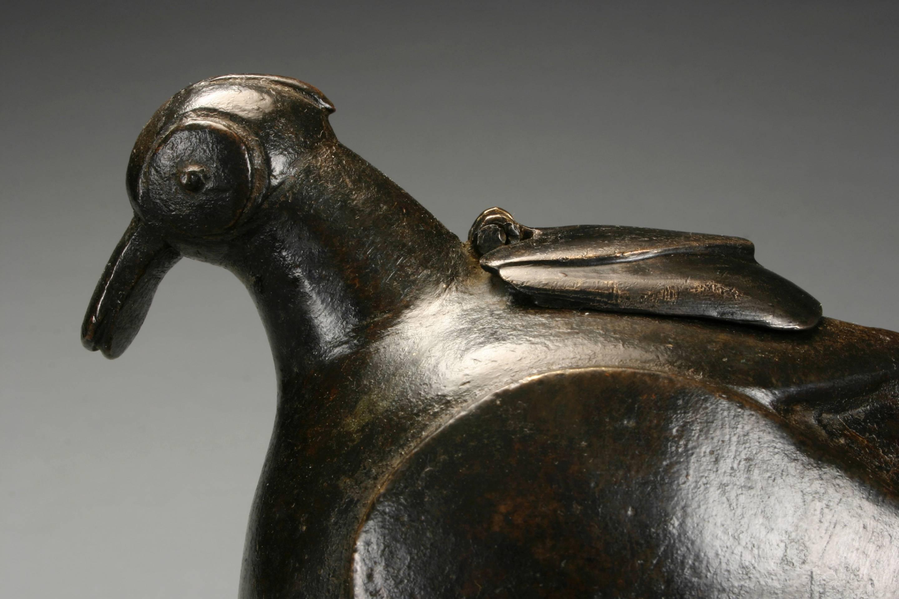 An Indian Patinated Bronze Sculpture of a Bird, 18th or 19th Century
A very handsome sculpture of a very bold form and attractive scale.
Of stylized form posed in an alert, upright position with a hinged cover on the back, on a stepped square base.