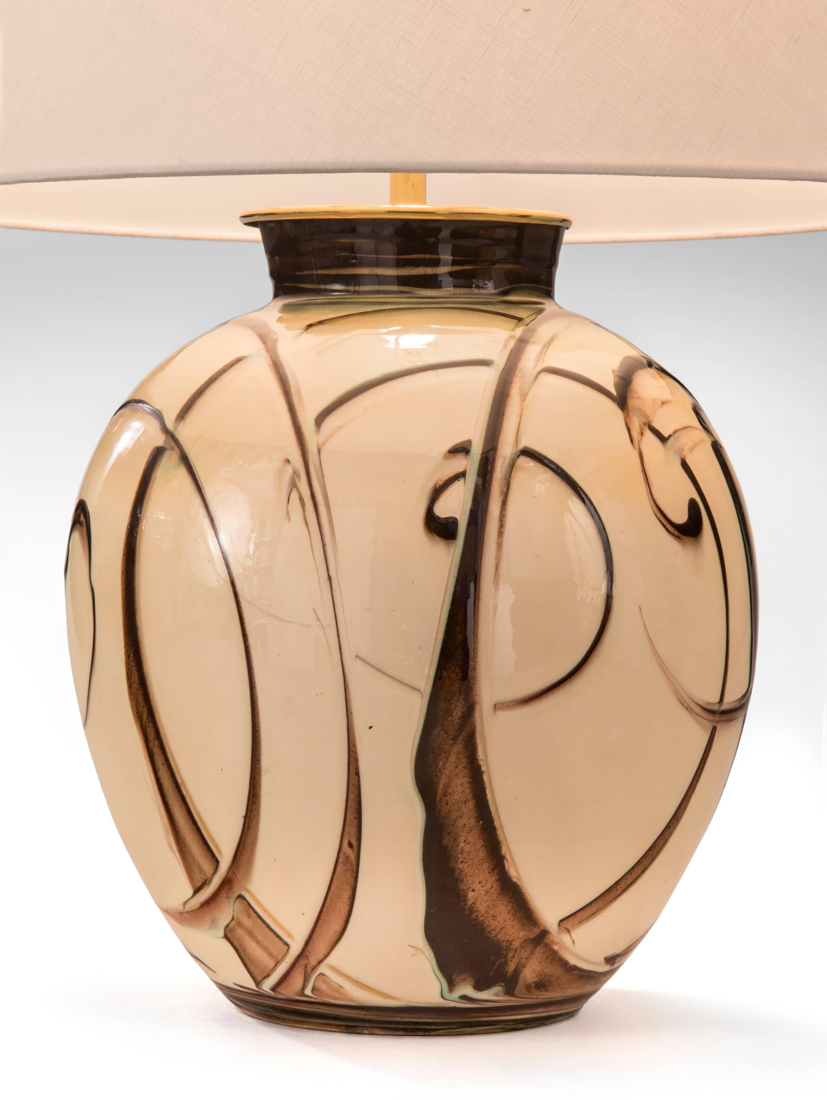 The flared collar, above an ovoid shaped body adorned in glazed overlapping spirals. Signed: HAK

Related vases are illustrated by Peder Rasmussen, Kähler Værk, Copenhagen, 2002, p. 206