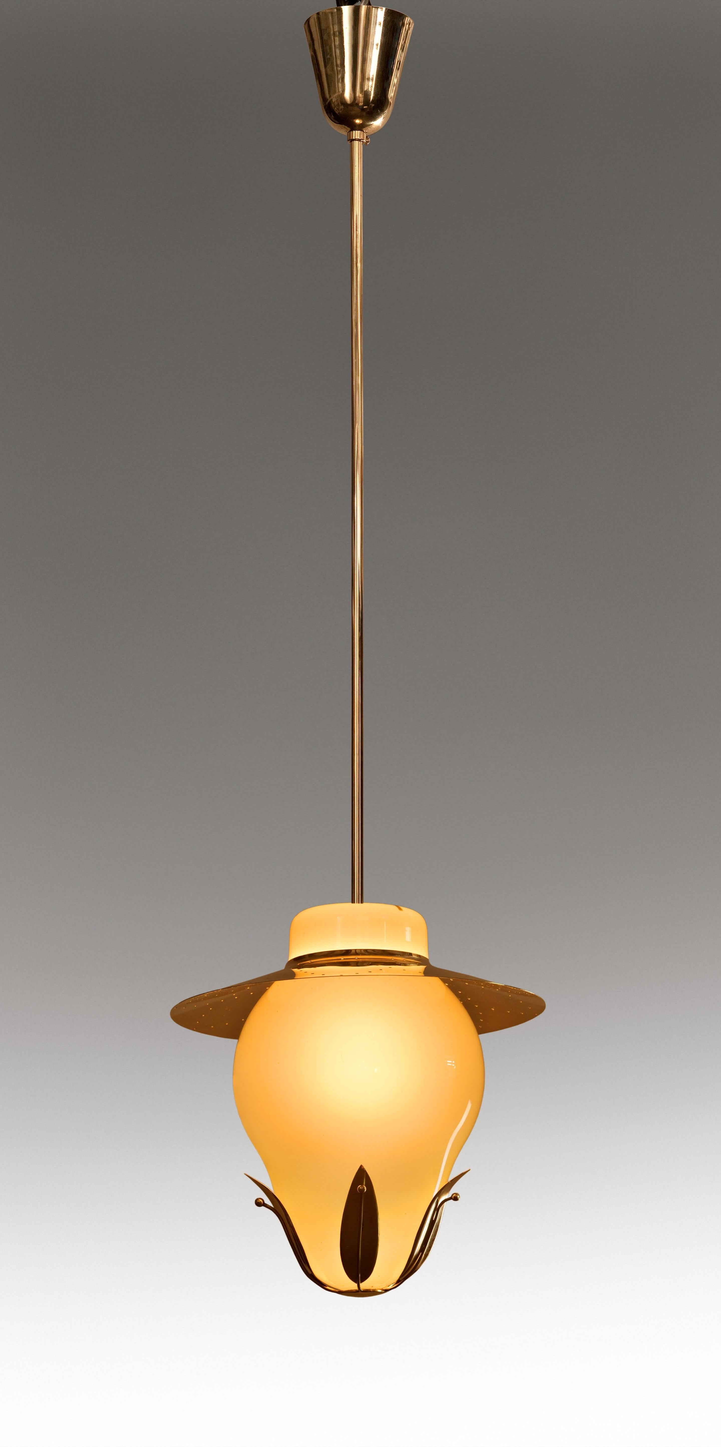 Paavo Tynell for Taito Oy, Finnish Opaline Glass and Brass Chandelier, Mid 20th Century
A lovely chandelier with gloriously colored glass and stylish brass. The conical corona, above a hanging rod joined to a shaped case glass diffuser, supporting a