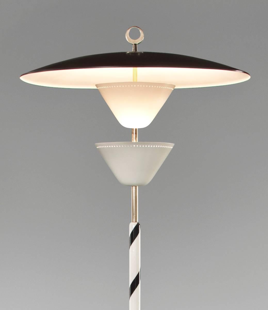 Stilnovo, Rare Italian Painted Metal and Brass Floor Lamp, Mid 20th Century 
A marvelous floor lamp demonstrative of Stilnova quality and innovative design. The ring-like finial, above a single down-turned reflector and two smaller up-turned