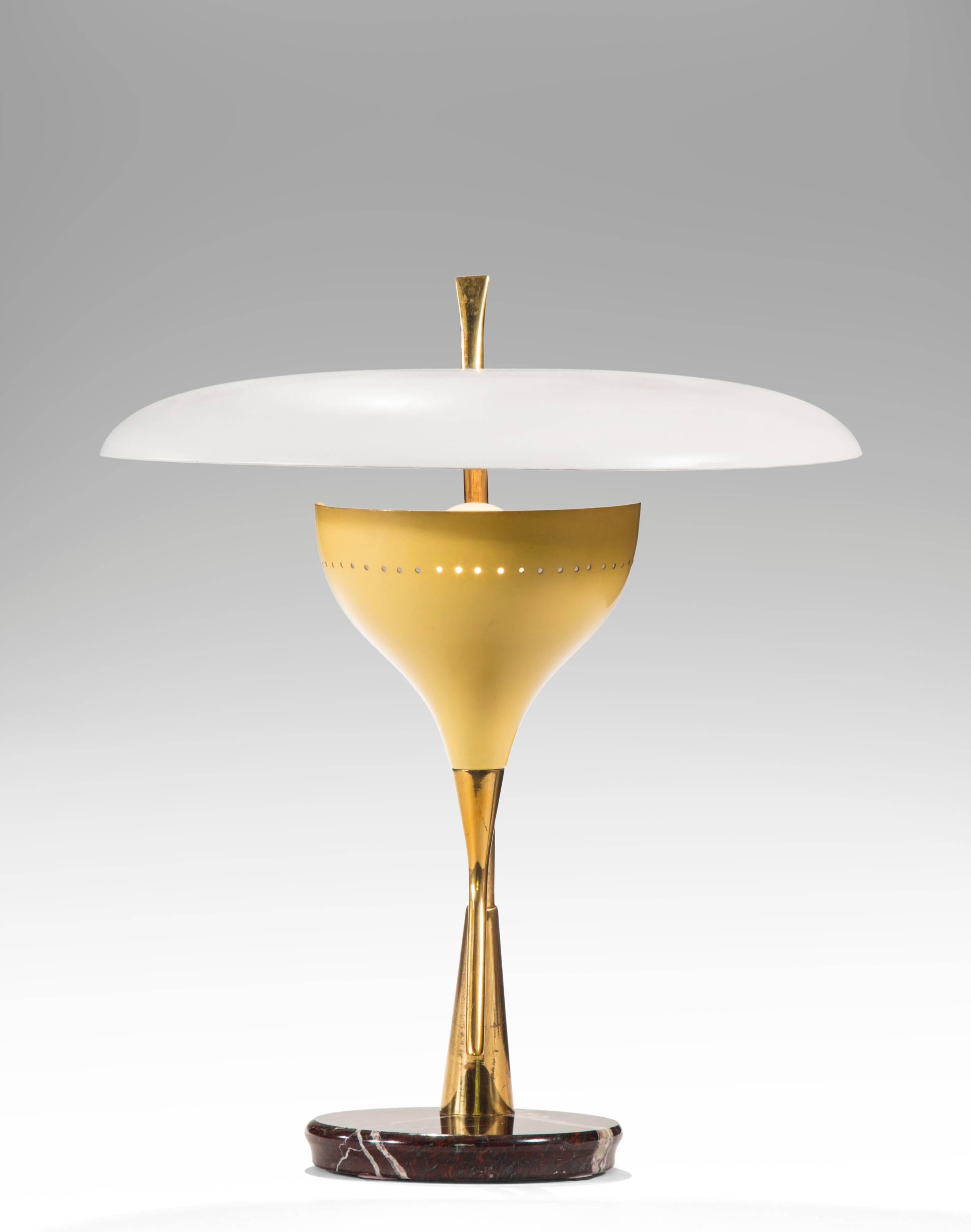 This choice lamp defines mid century Italian design at its best. The circular white shade above a pale yellow light holder both raised on angled brass supports, with a reverse beveled circular marble base. All materials of very good quality