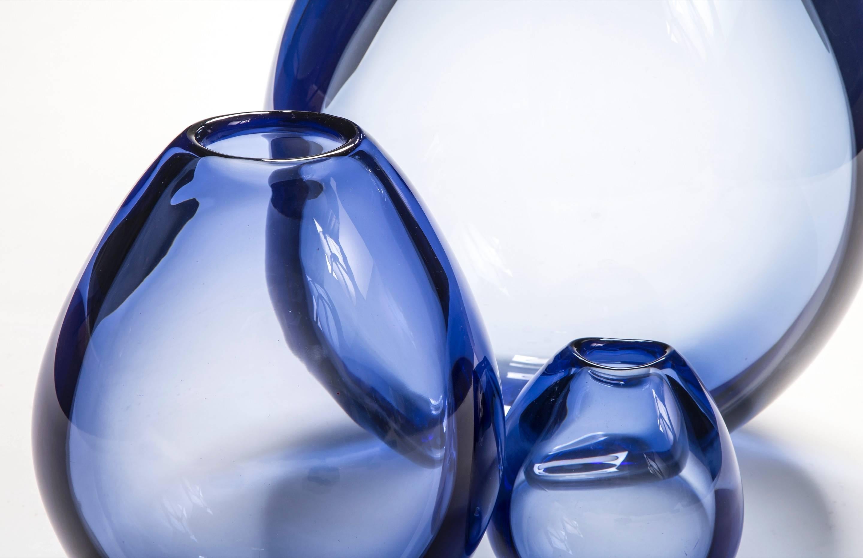 A perfect fusion of form and color creates these ethereal vases. The largest vase of this set was made in a limited quantity and is rarely available.

Of graduating size tear drop form with small concave openings. Small vase signed: Holmegaard PL
