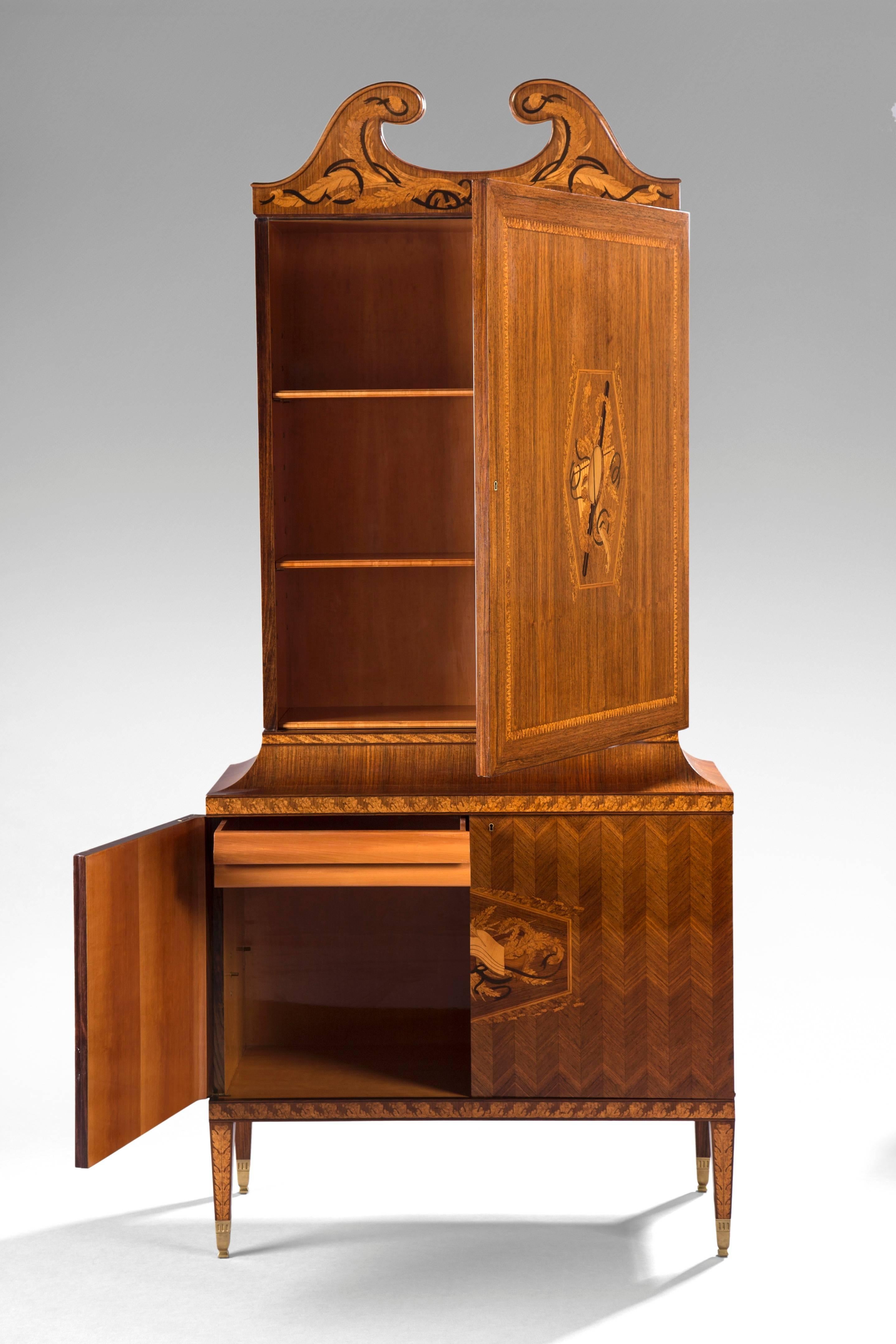 A superb example of the finest 20th century inlaid wood marquetry; the cabinet boasts two deftly executed trophy reserves and a glorious crown designed by Gio Ponti's protégé Giovanni Gariboldi. The acute attention to detail creates a wonderfully