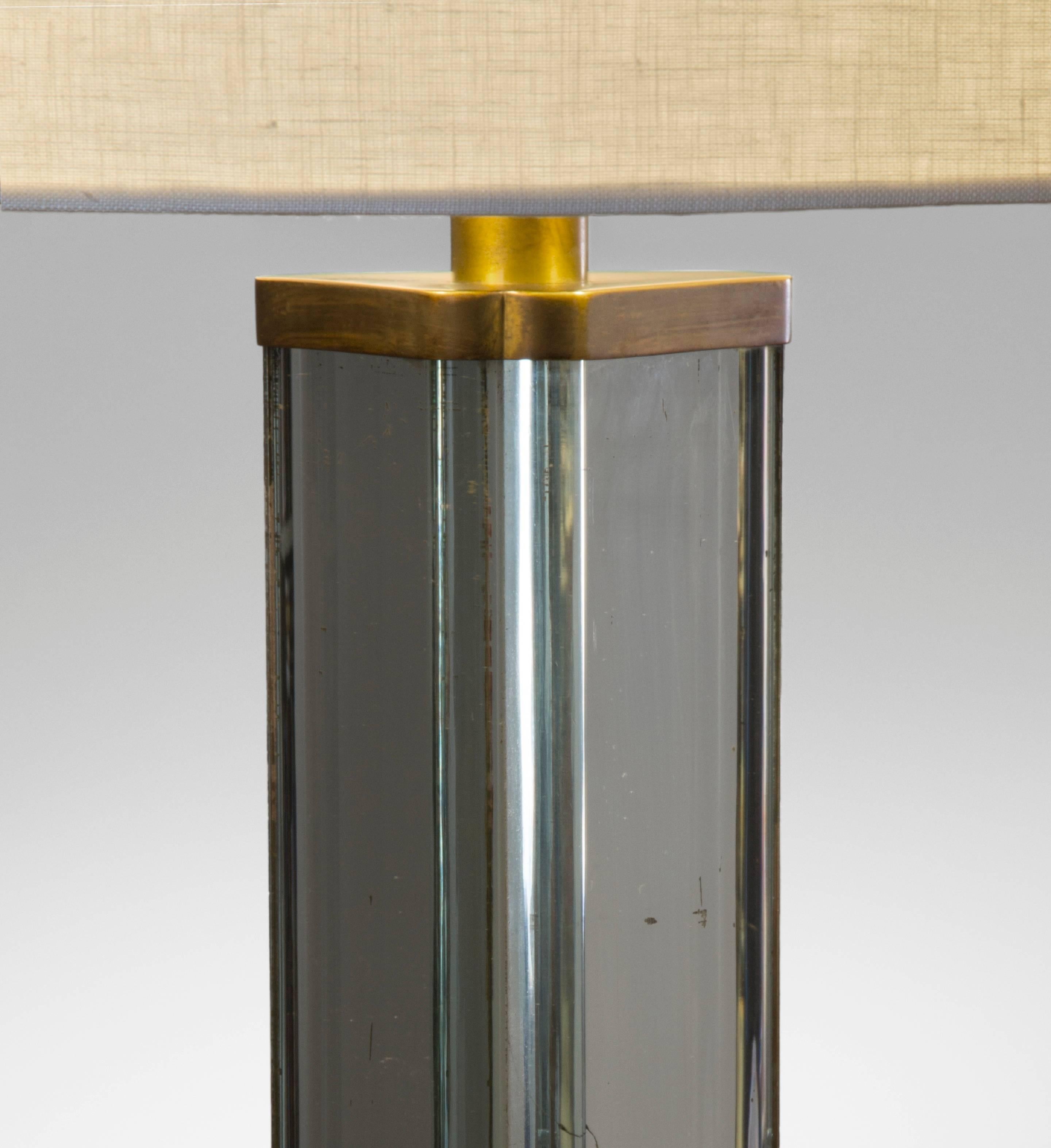 Pietro Chiesa Attributed, Italian Patinated Brass and Mirror Glass Floor Lamp

A very fine example of Chiesa's effortlessly modern and sophisticated style. The triangular standard clad in rounded planes of substantial mirror glass, floating above a