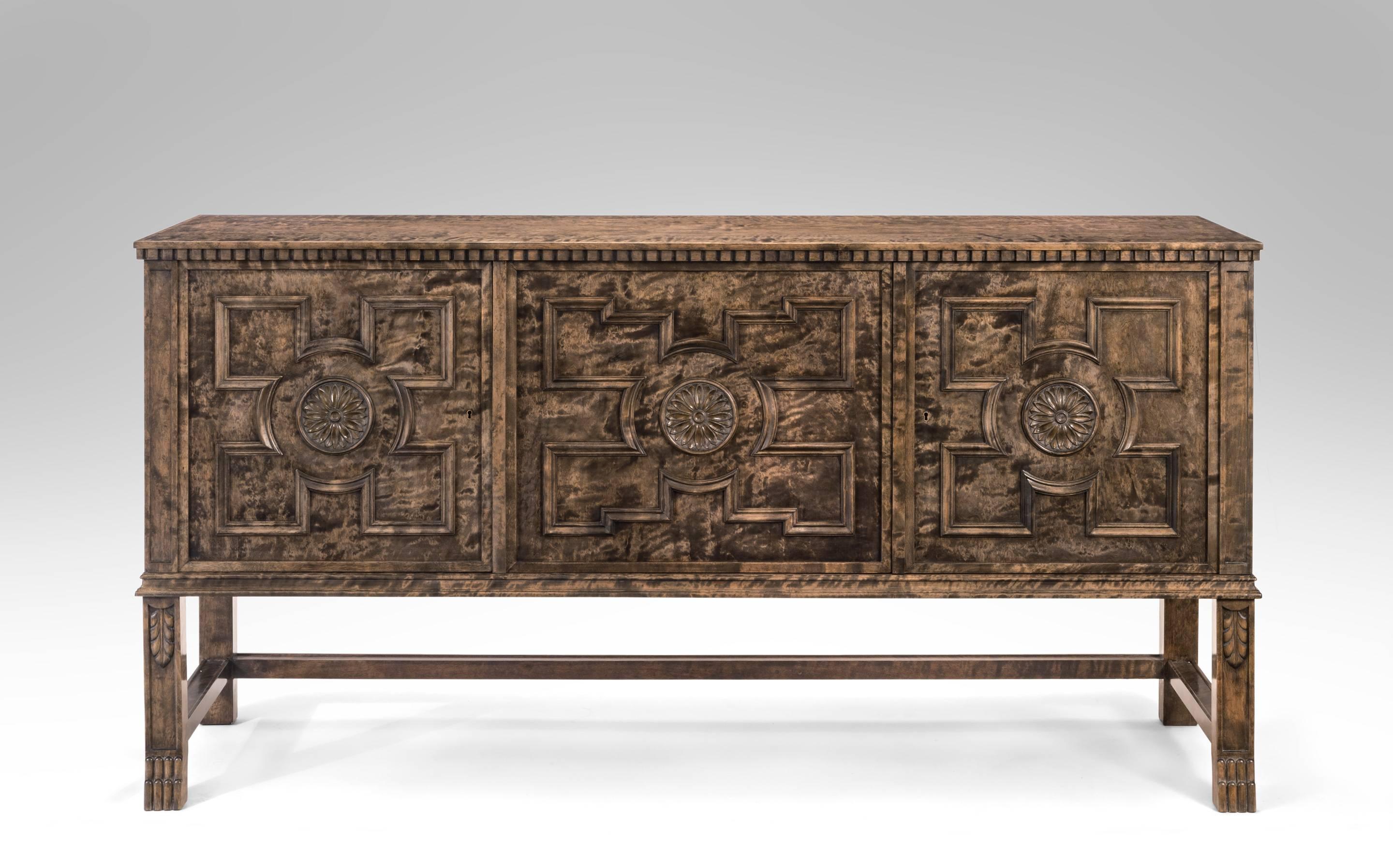 A rarely available pair of superbly crafted works from the master of 20th Century Swedish design. The rectangular top, above a molded frieze, over three cabinet doors, each door centering a rosette surrounded by geometric molding, opening to