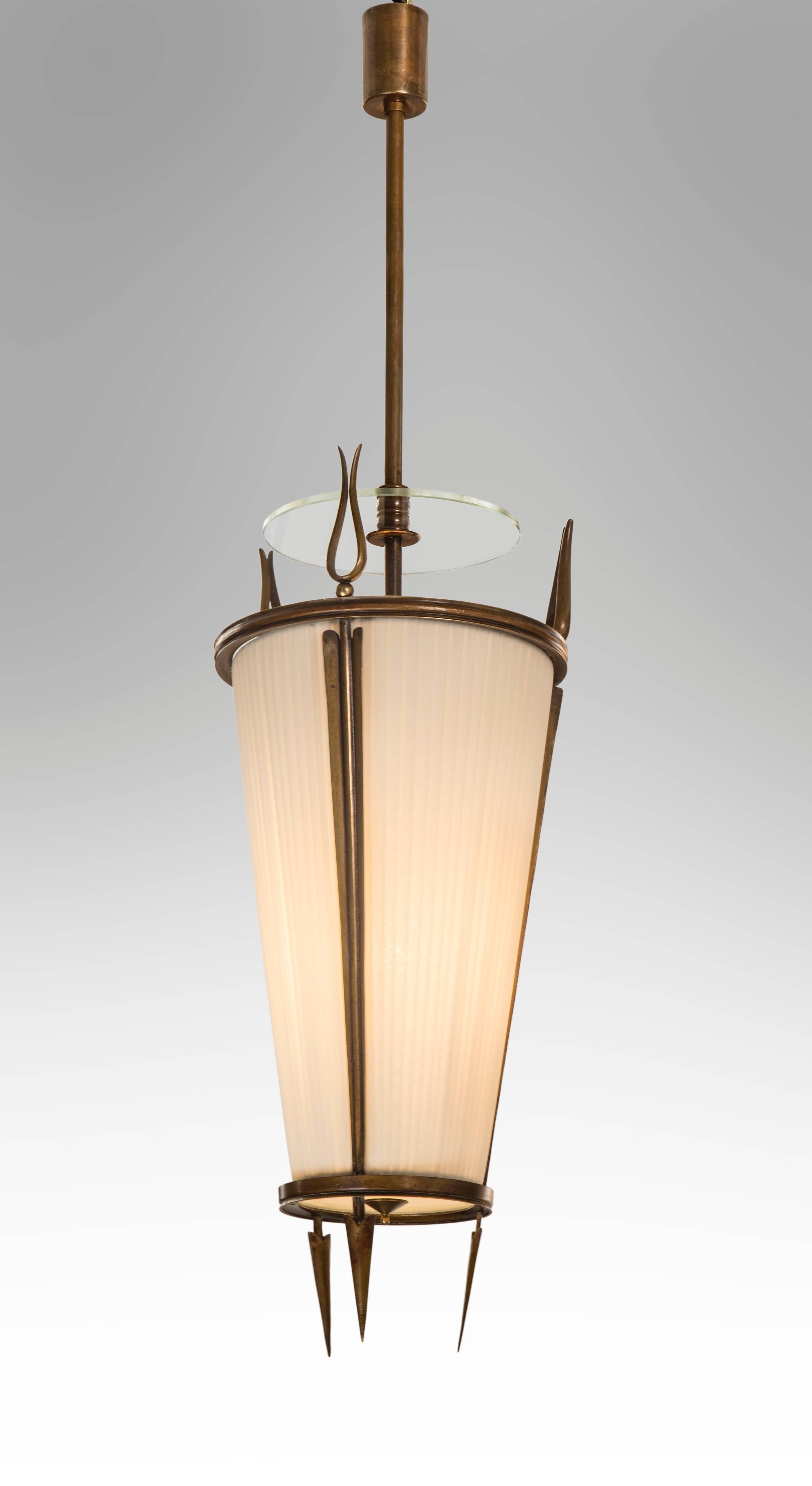 The cylindrical canopy above a suspension rod centering a floating glass disc, the conical body with a fabric shade framed by stylized arrows.

The same model lantern is illustrated by P. Buffa and A. Cassi, Decoratori e Architetti Contemporanei,