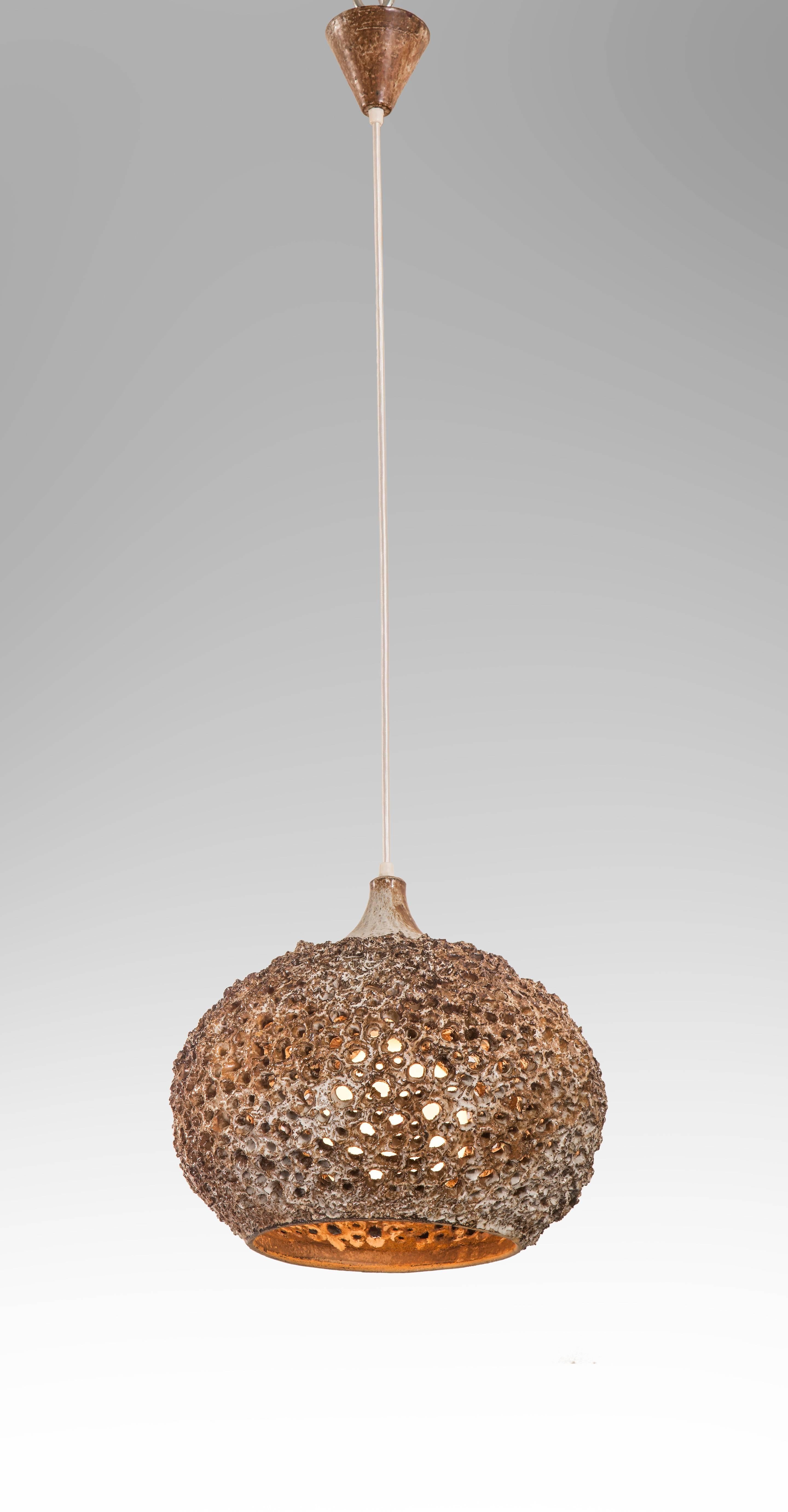 Intriguing and innovative chandeliers with delightfully unexpected openwork construction. Each with a variegated glazed canopy, above a cord suspending a perforated ceramic diffuser. 

Height is easily adjustable. 
Overall height: 53"
Diffuser