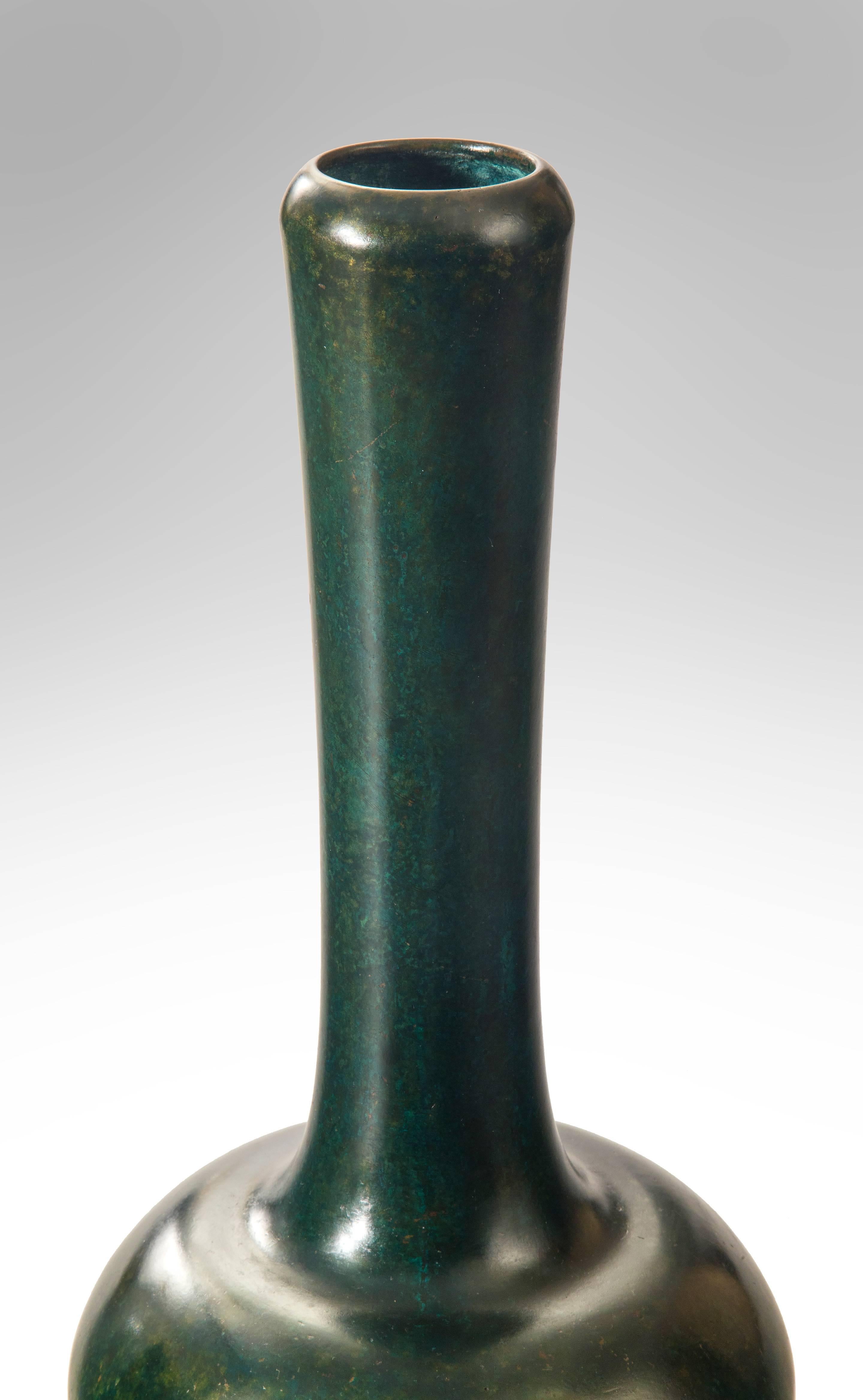 An fascinating vase inspired by classical Chinese ceramics now impressively transformed in richly patinated bronze. Of bottle form, the circular inverted mouth above an elongated neck, with a tapering spherical body, vibrant green patination