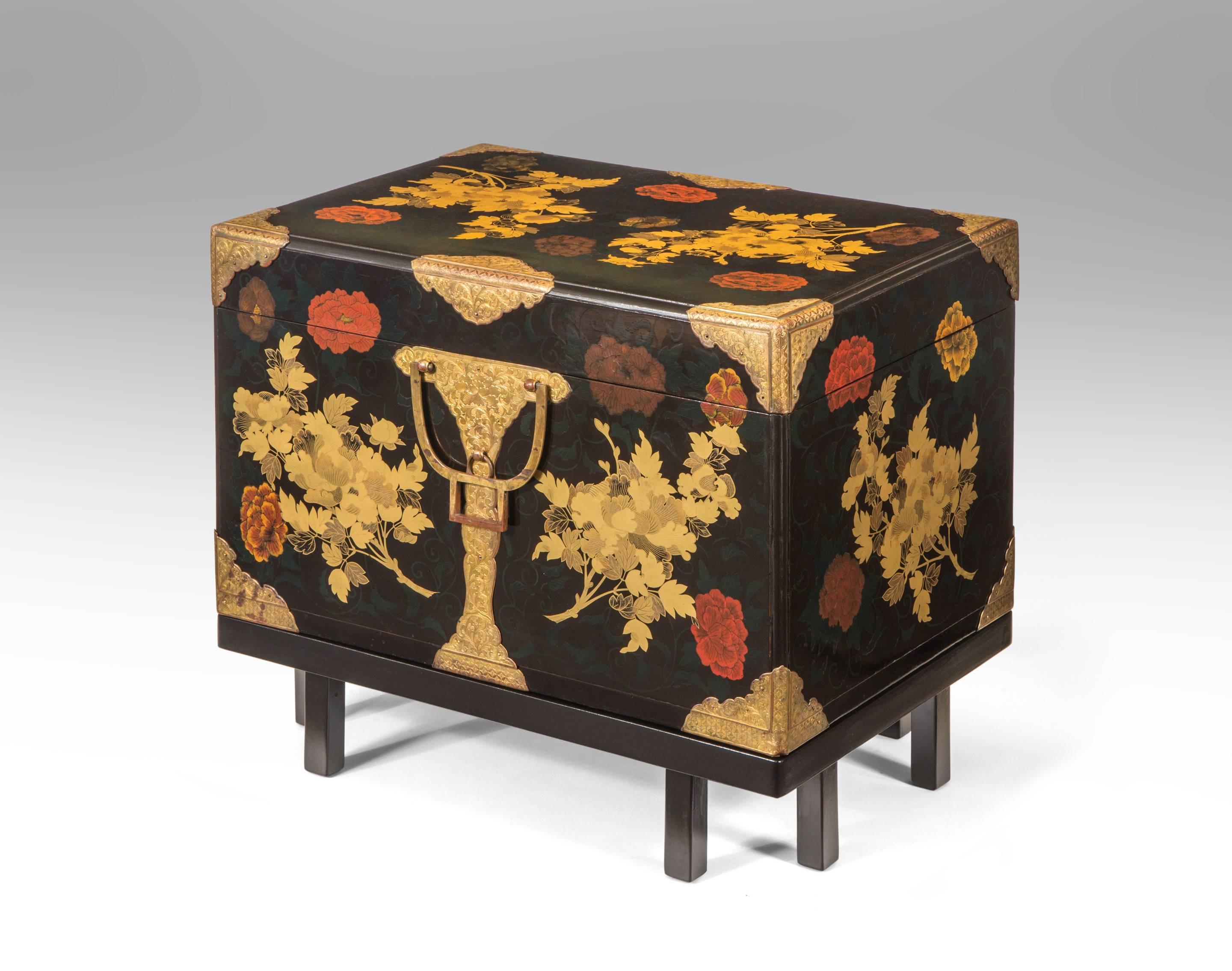 This gorgeous box is a rare example of decoration inspired by the Rimpa period. The whole adorned in golden peony branches against background of green trailing vines and polychromatic peony blossoms, the gilt copper mounts also engraved with