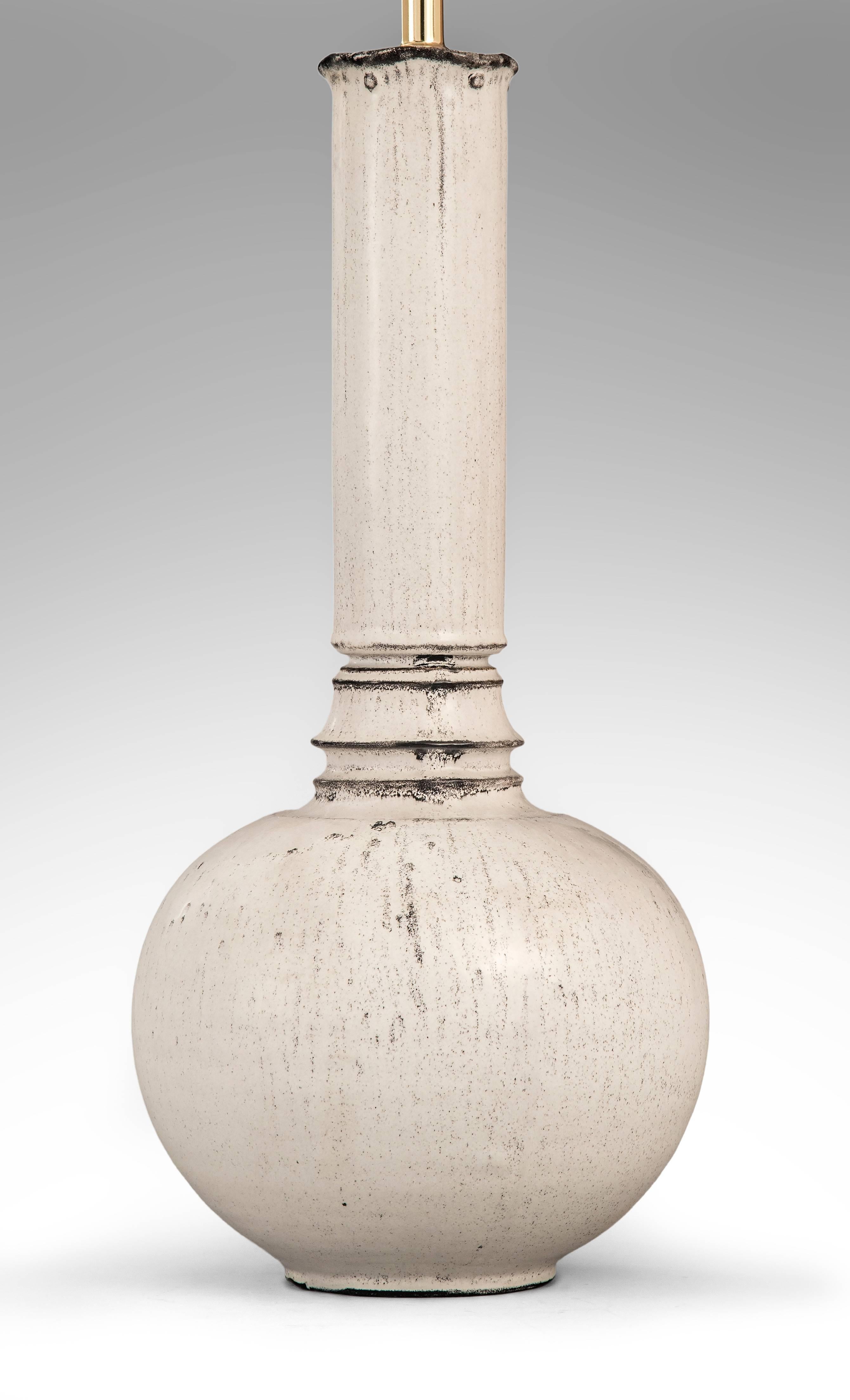 An outstanding form of impressive scale and beautiful glaze. The undulating rim on a cylindrical neck above a bell-form collar, terminating in a spherical base. Signed HAK. Made in Danmark