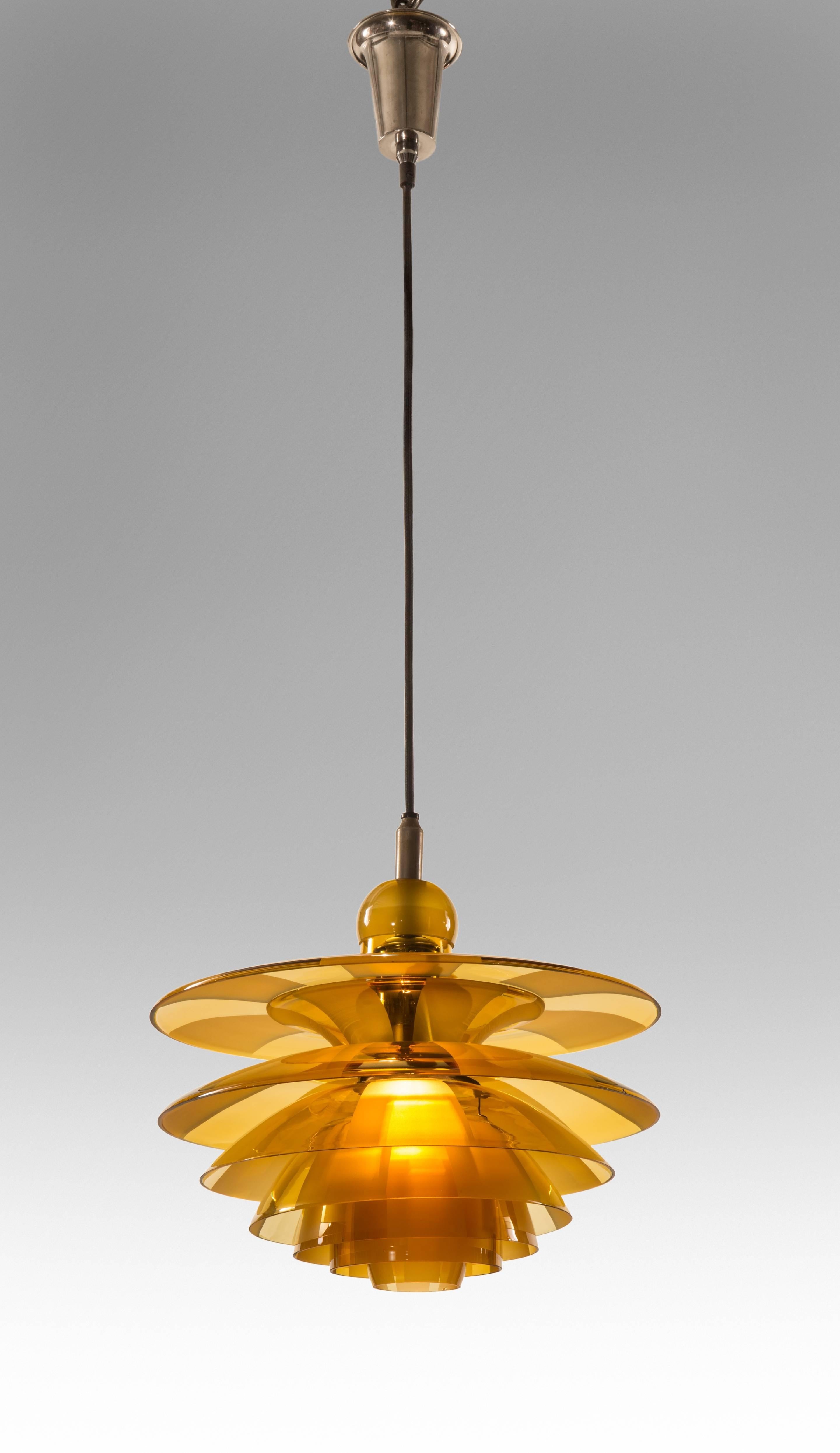 A Rare Danish Amber Septima 4 Chandelier 
Simply beautiful, perhaps Henningsen's most alluring design. The conical corona, above a composition of seven graduated glass shades with overlapping frosted glass fields. A stabilized and almost invisible