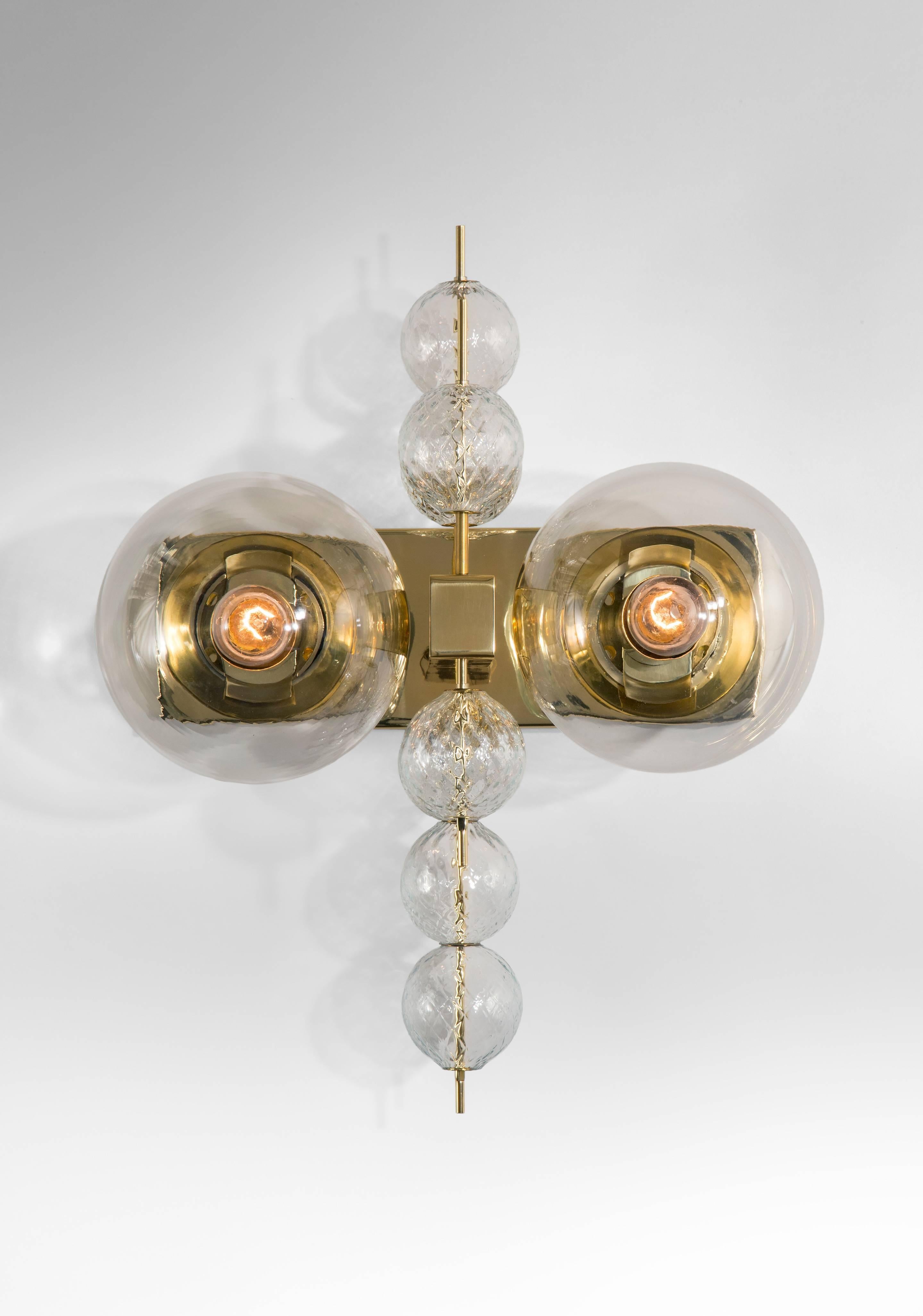 A spirited and chic design. Each rectangular backplate, issuing two illuminated glass globes centering  two rods supporting floating glass spheres.
 
In great overall condition, ready to add to your collection.