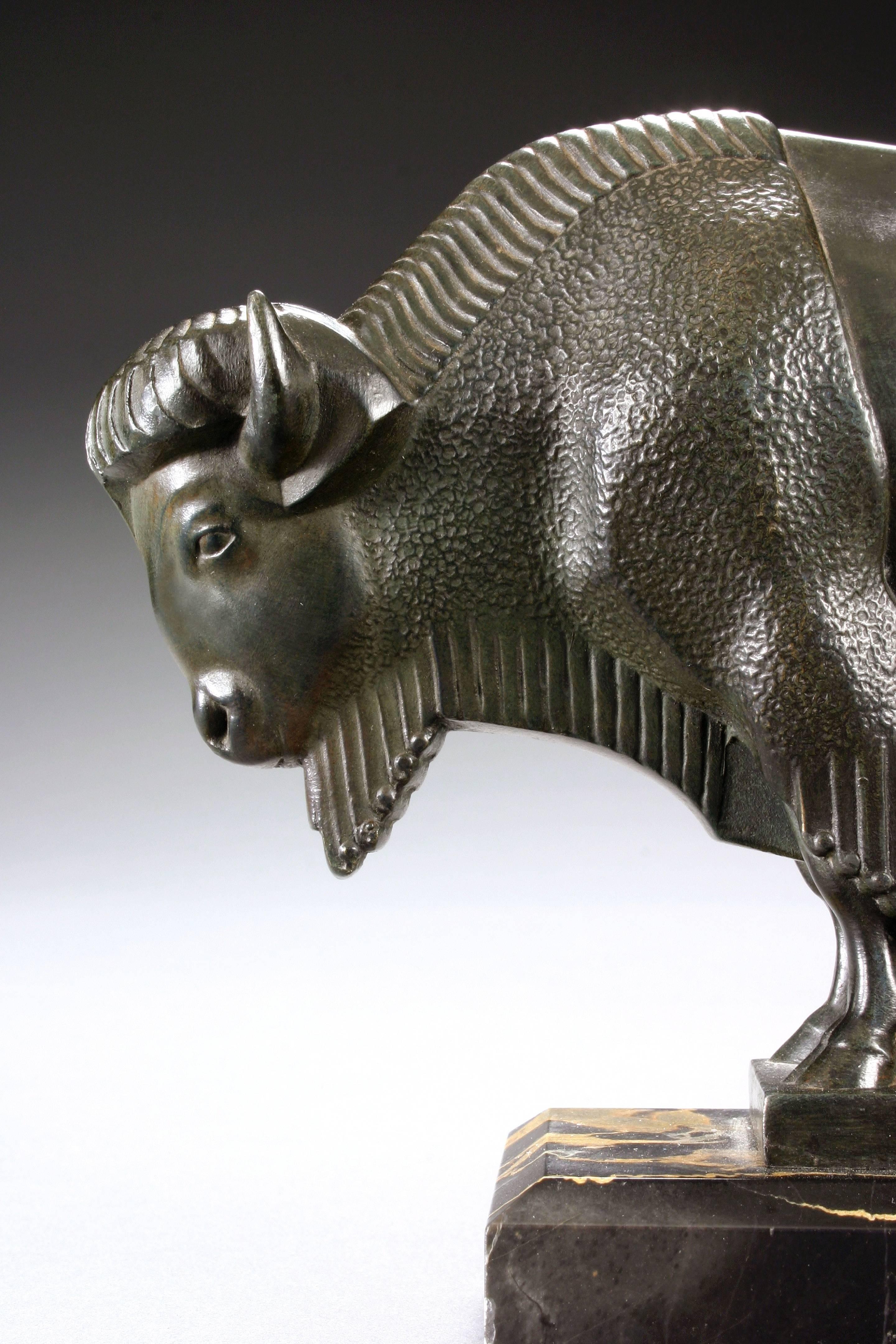 Each bison leaning forward on a rectangular Portor marble base. Signed: M Le Verrier 