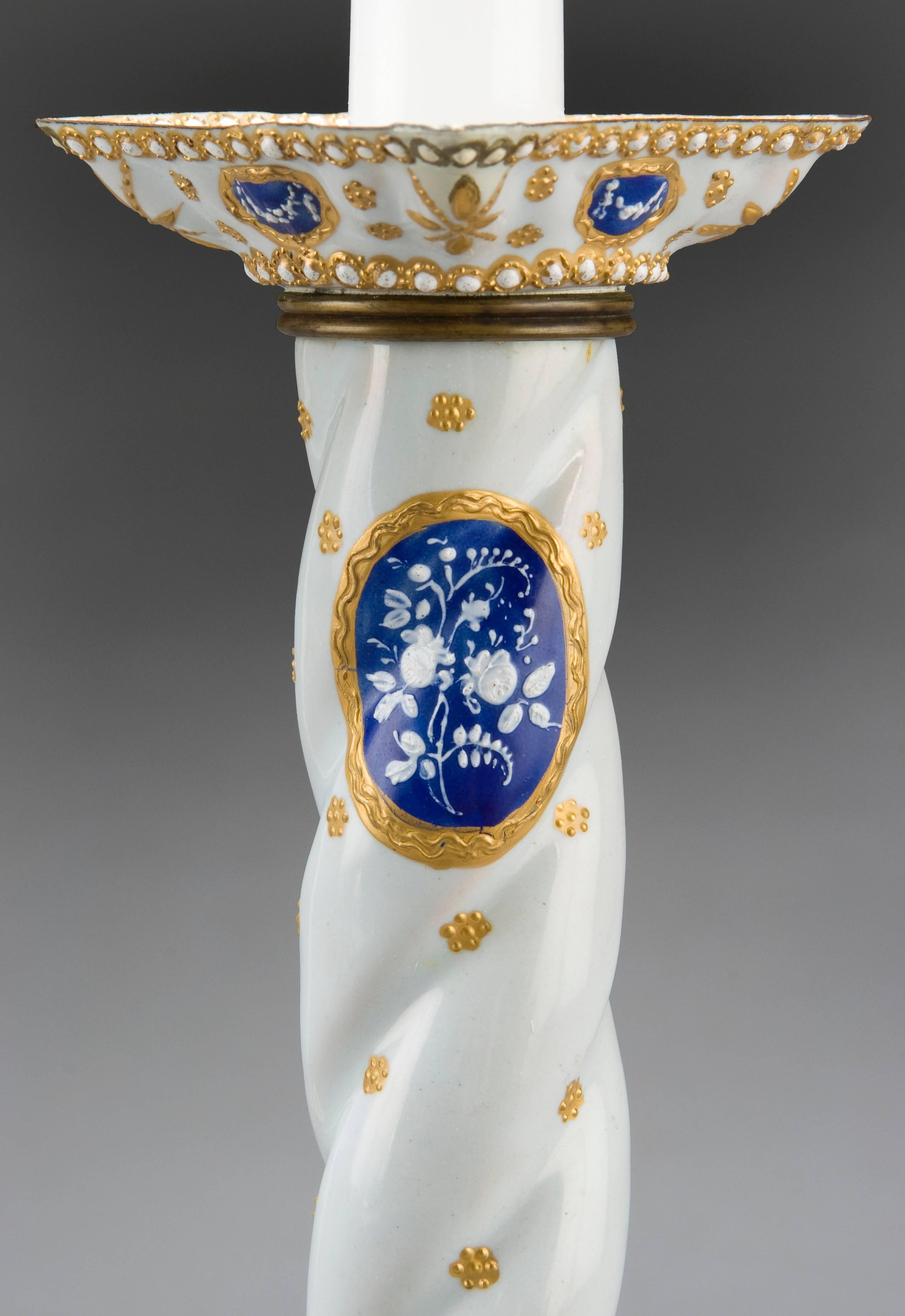 Charming and fine example of Staffordshire enamel ware. Each with spiral stems above square tapering bases, decorated with gilt-edged blue oval panels of white flowers. 

Very good antique condition with expert minor repairs, overall a delightful