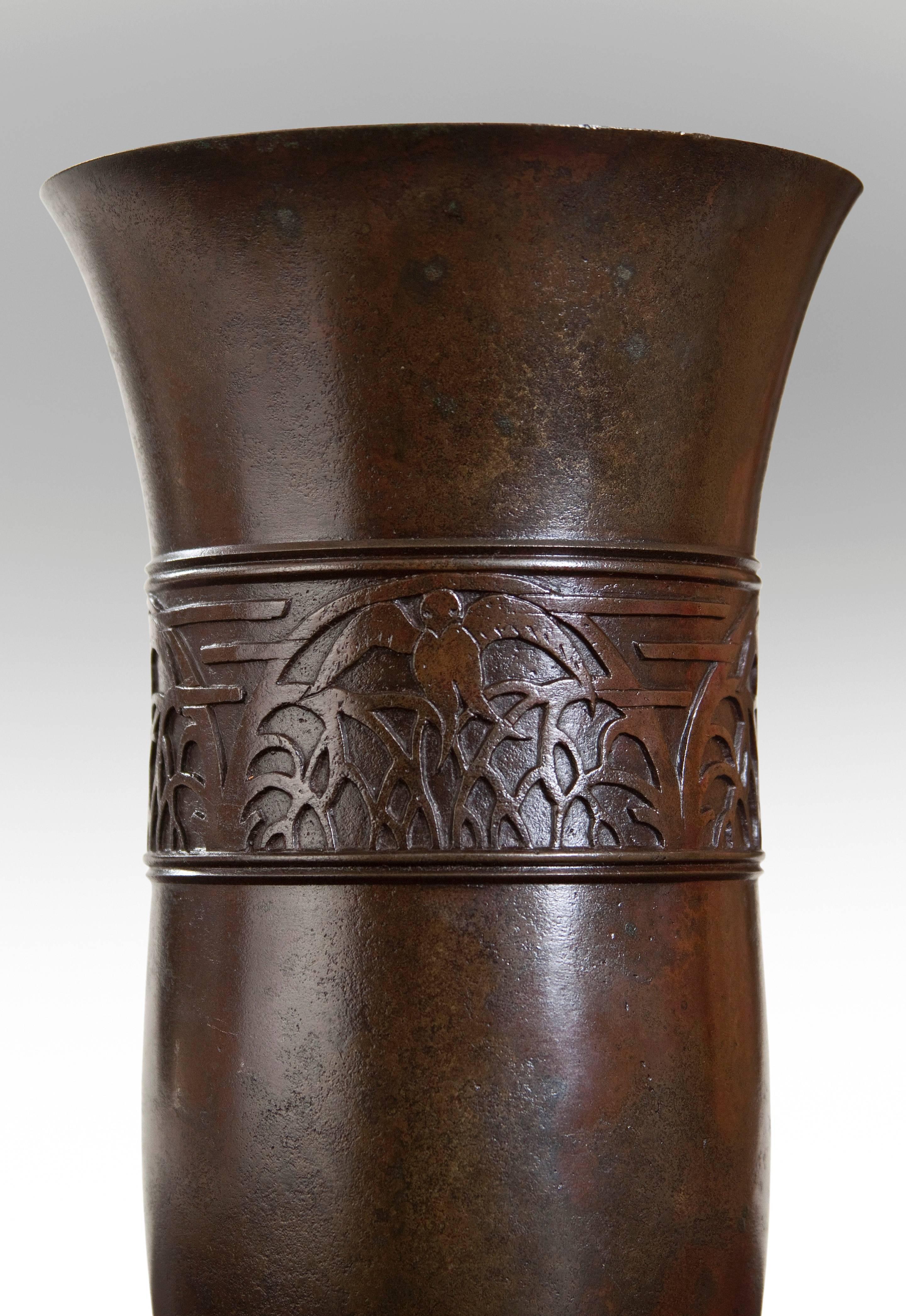 A rare example of an evocative bas relief decoration encircling the vase. The circular flared mouth, above a relief of birds alighting on fractal branches, on a base with multiple circular bands. Signed: Gado
This very good example of a Japanese