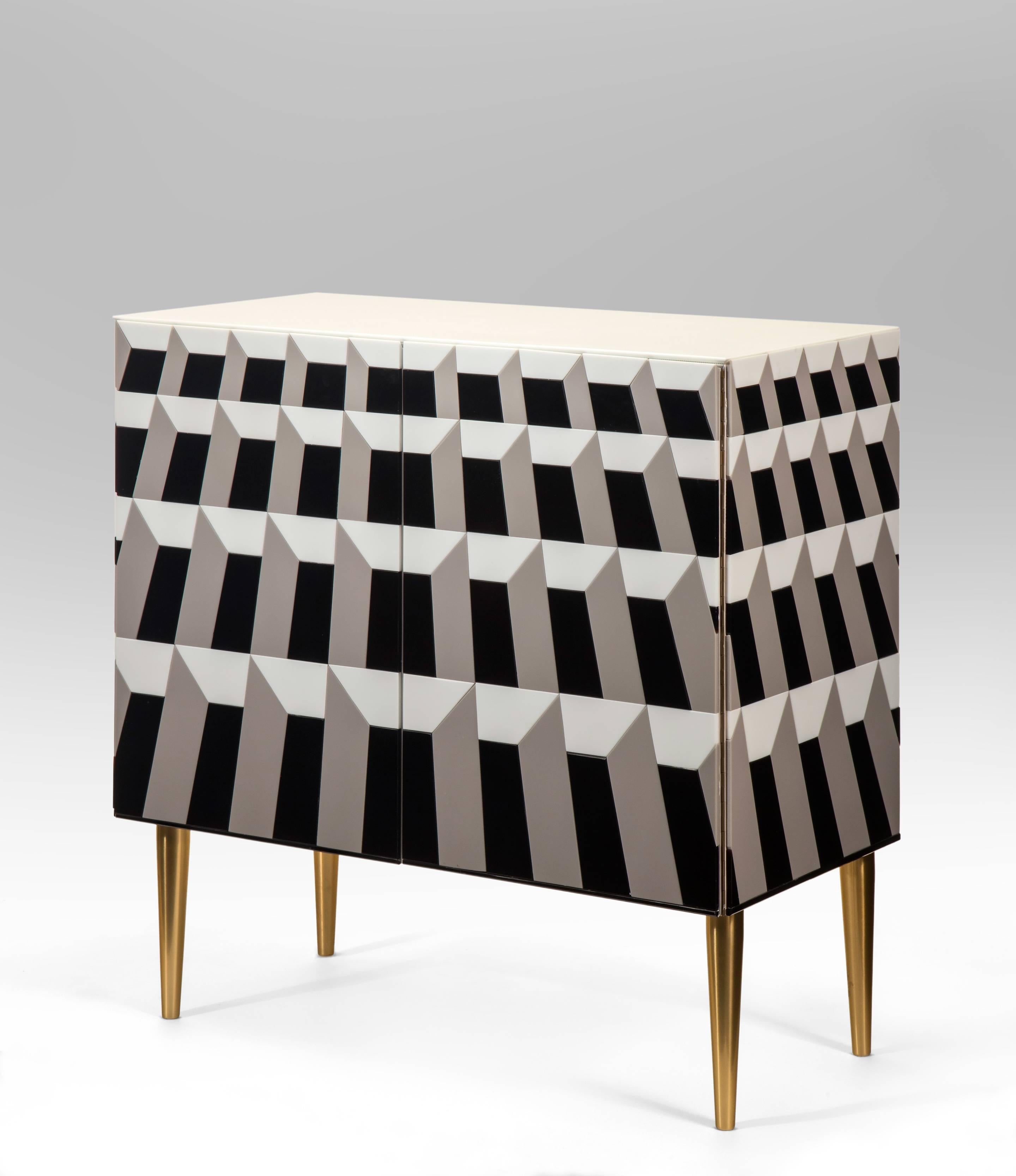 A stunning limited edition made exclusively for HM Luther. The rectangular top above two doors, raised on brass feet, the cabinet composed of vintage white, gray and black opaline glass in a geometric trompe l'oeil design. Signed: R.G.RIDA
