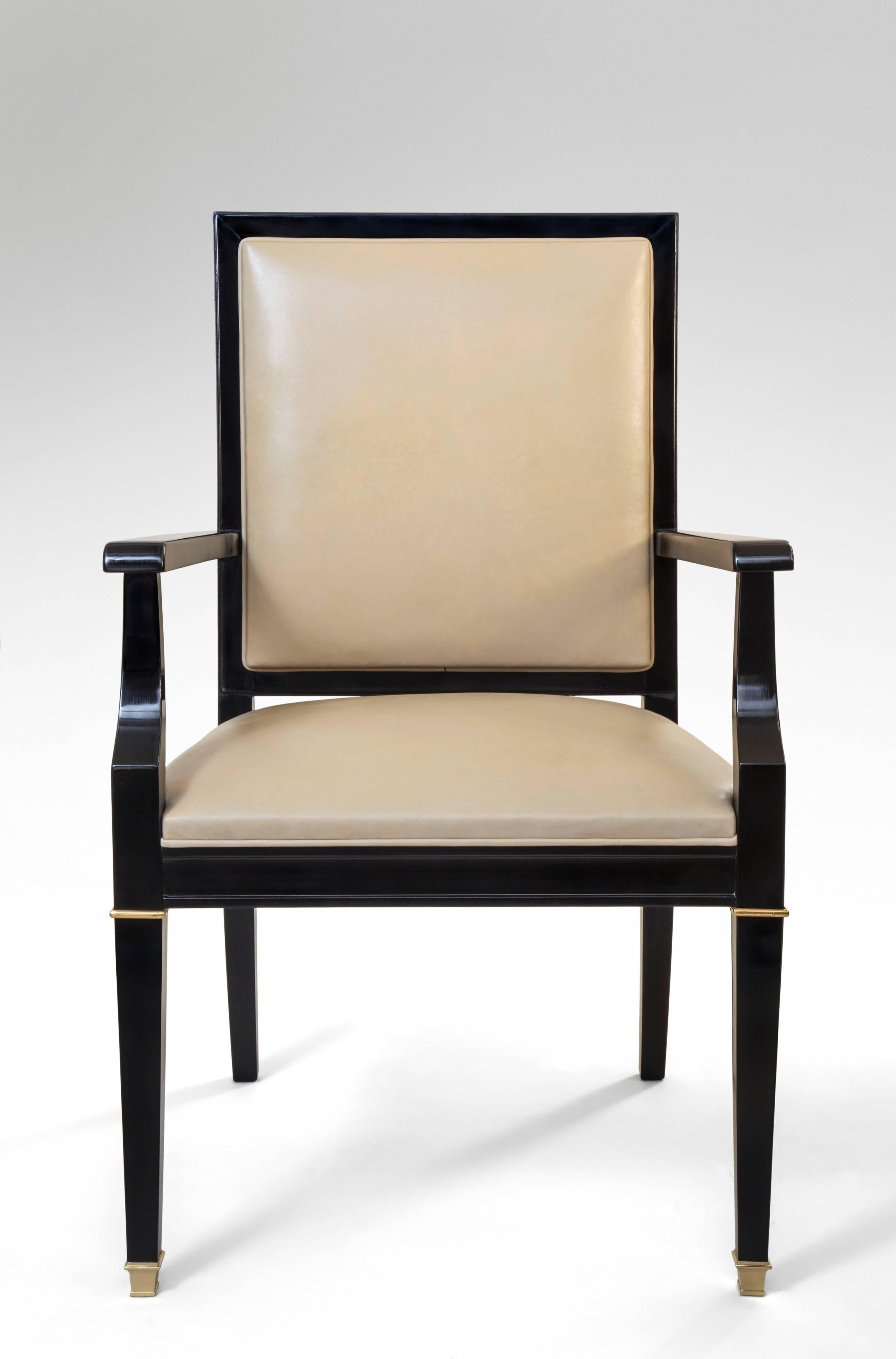 De Coene, Belgian Brass Mounted Black Lacquer Armchair The leather upholstered rectangular back and seat, with arms ending in scrolls, on square tapering legs front and saber legs back. Original leather worn.

Another chair available.