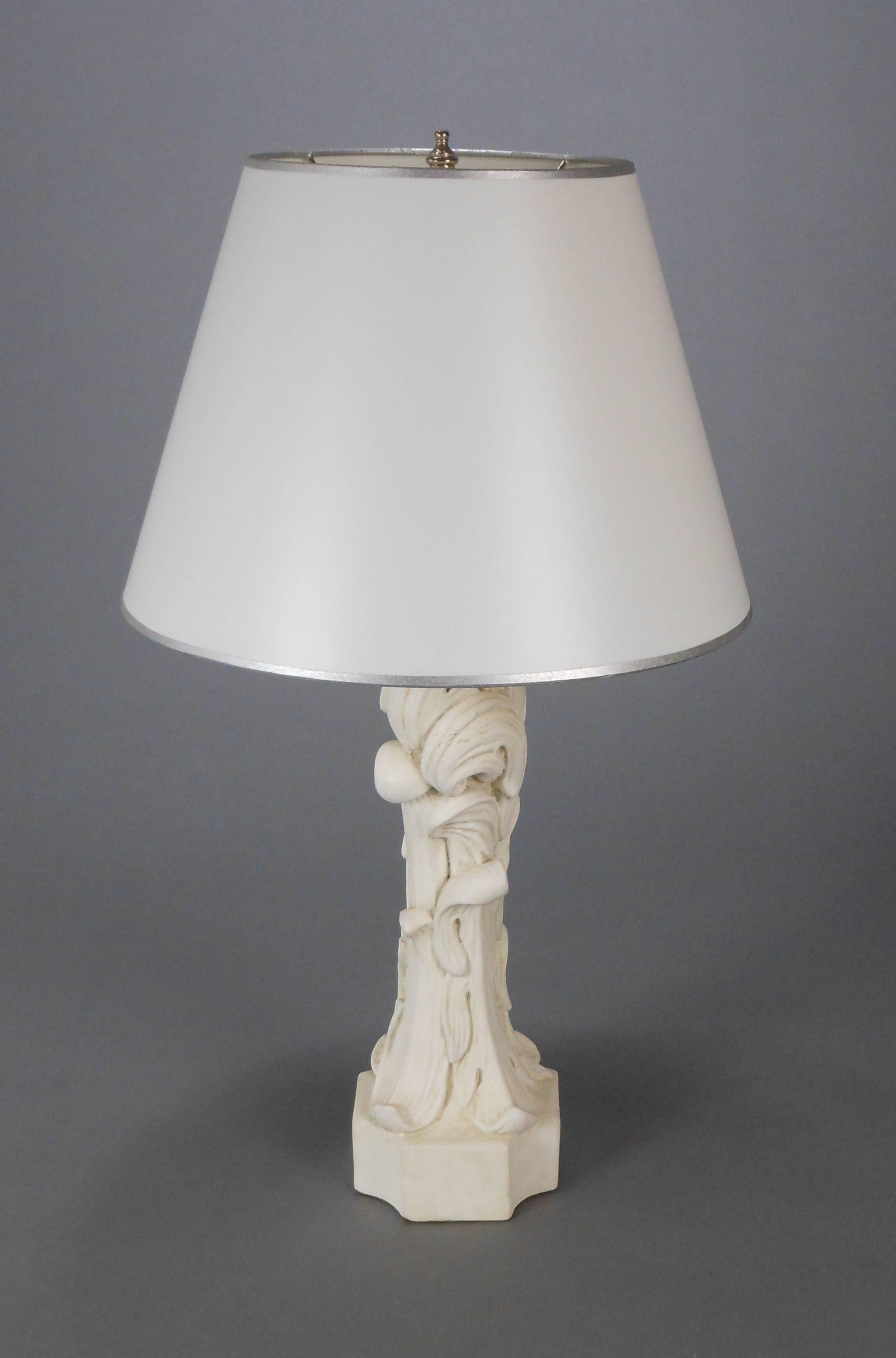 Each in the form of scrolling acanthus leaves on a square base with concave corners.

Height to base of light socket: 15.5