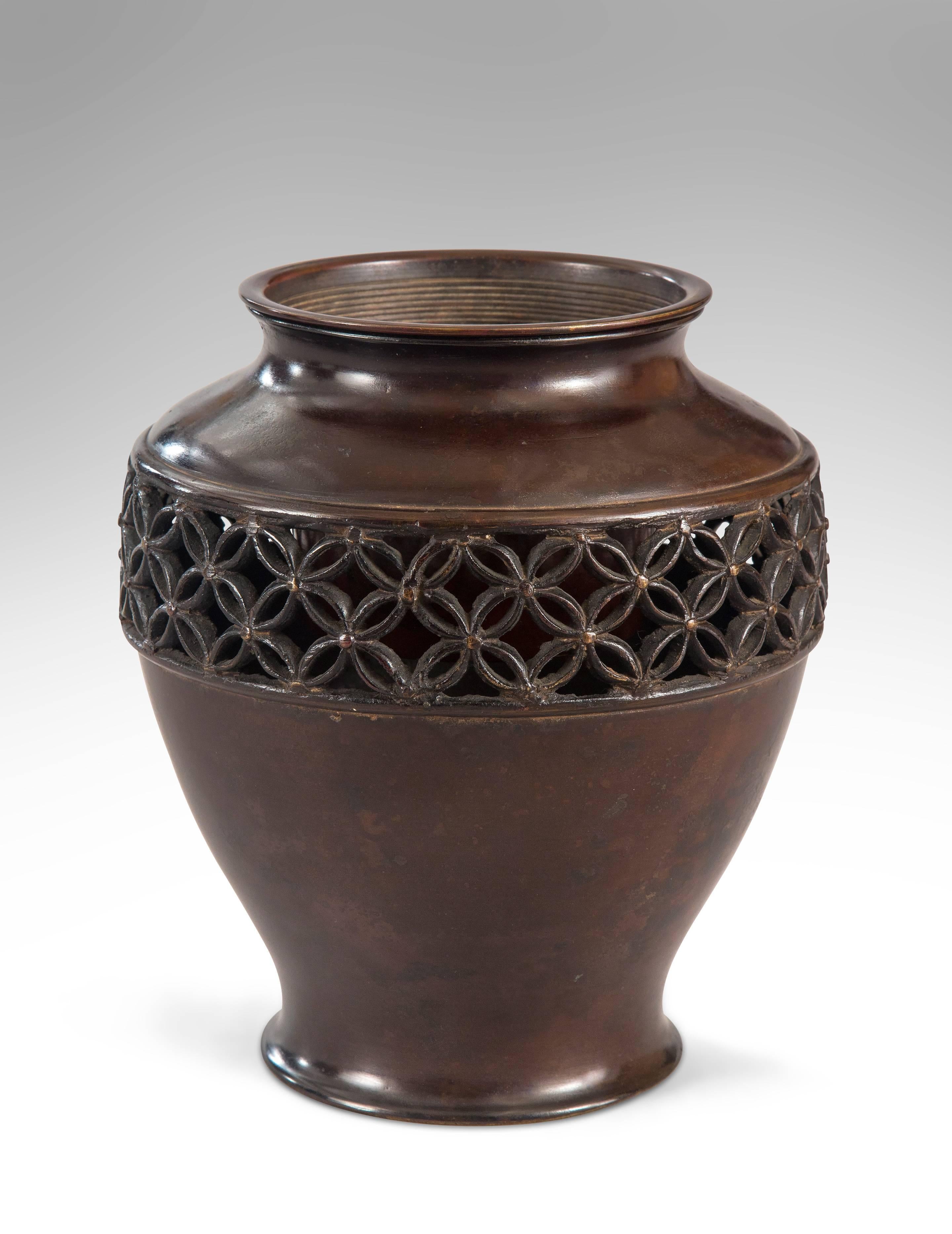 Beautifully patinated and a fine cast of substantial weight. Banded with an openwork frieze and a liner. A very good Japanese bronze vase.