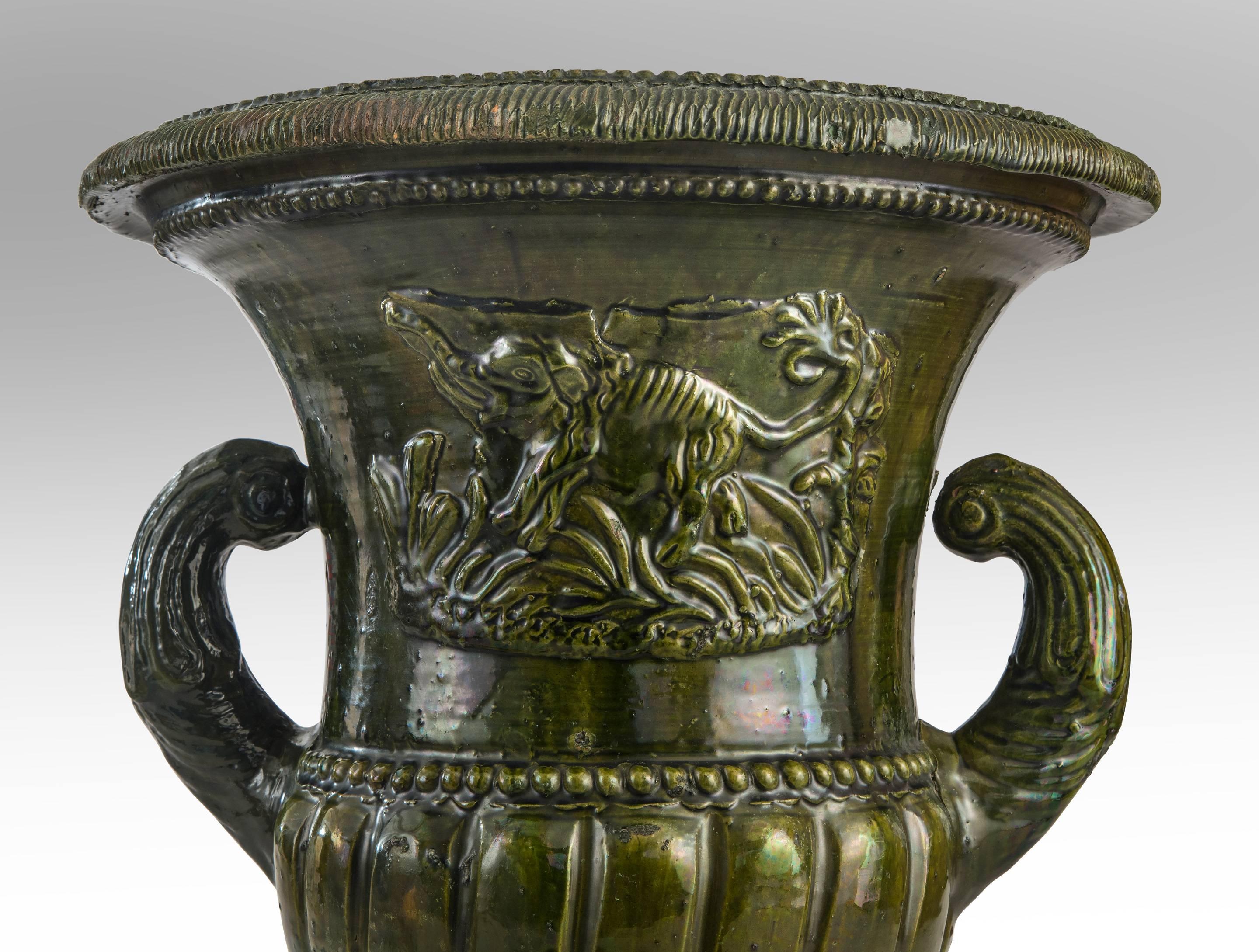A French Green Glazed Faience Campana Urn with Elephant Relief In Good Condition For Sale In New York, NY