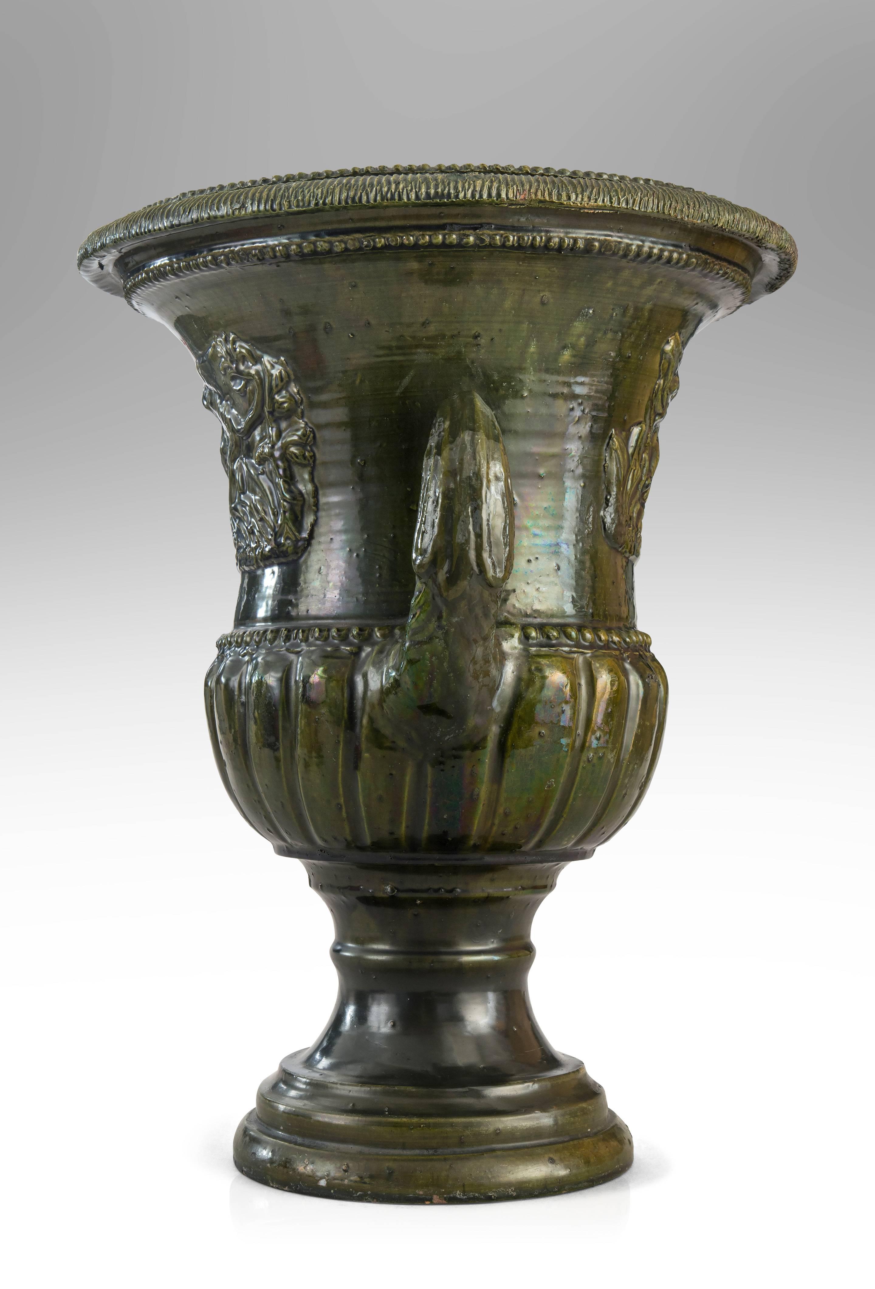 Beautiful modeling and richly glazed with a complex antique green. A French Green Glazed Faience Campana Urn with Classical Relief 

 Very good antique condition, ready to add to your collection.