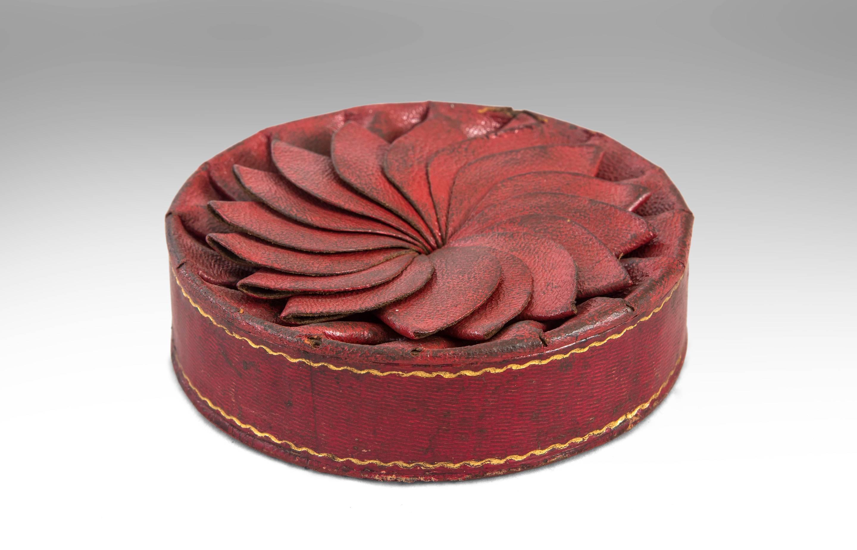 A joyful small box of surprising originality, a small wonder. The overlapping spiral folded top above the gilt tooled circular sides. Embossed: J. Chr. Lübber den 18 Junii 1836.