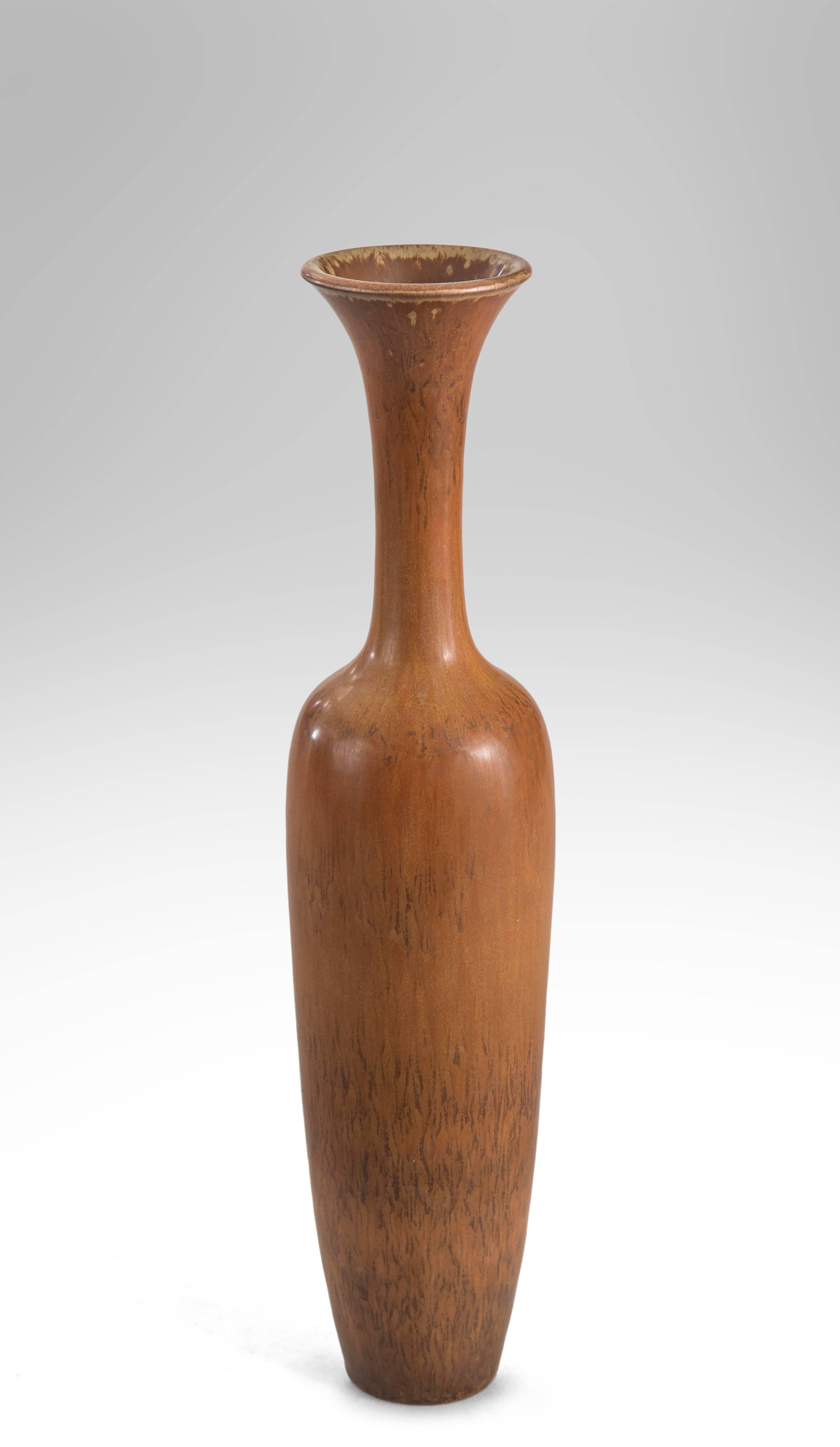 The flared mouth above an elegant, high-necked ovoid body, in a rich variegated brown glaze.

Excellent condition and ready to add to your collection.