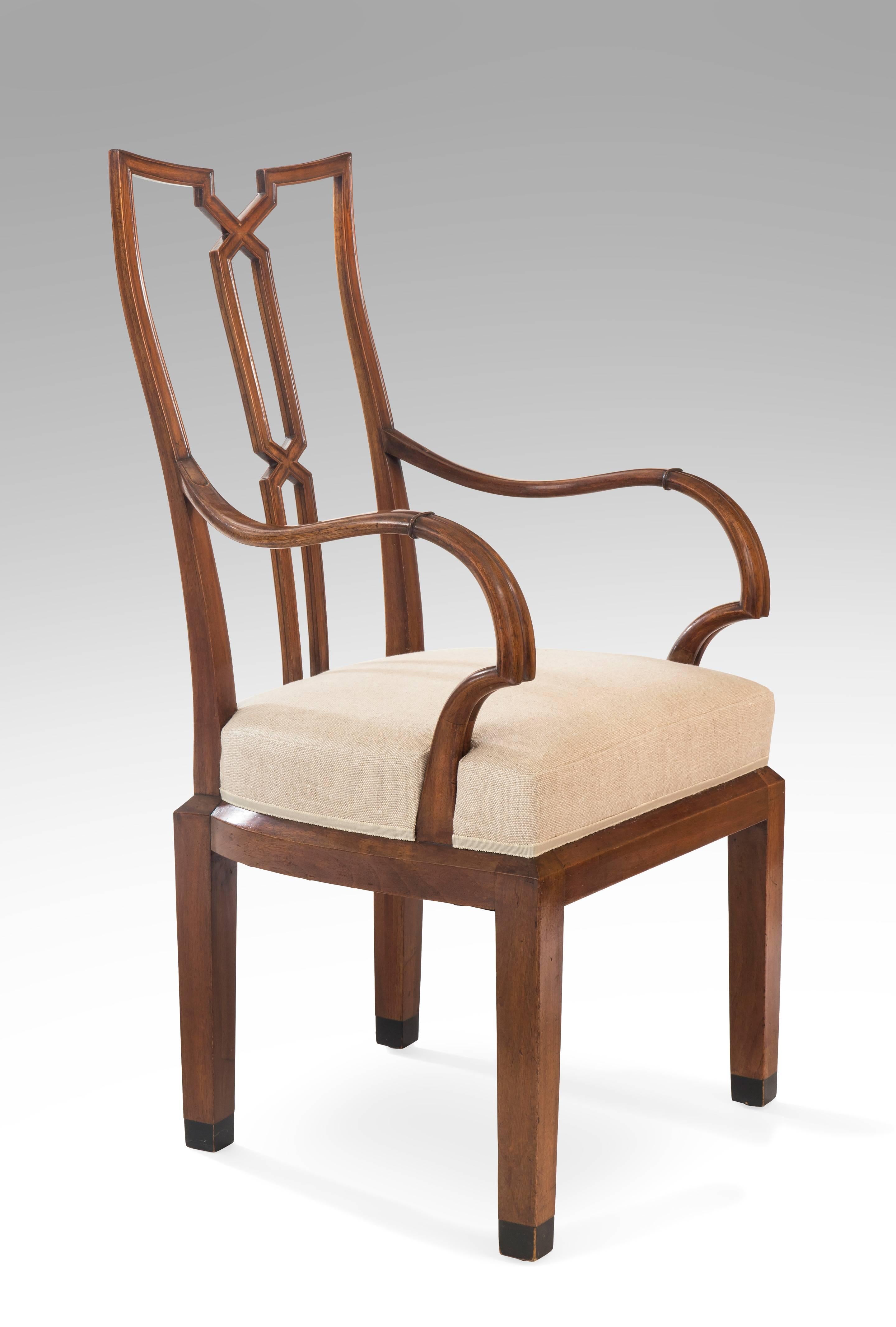 Stylish, comfortable and of impressive scale. The bisected toprail, above a molded x-form splat, the  curvaceous back issuing sinuous armrest above a chamfered apron, the chamfered legs with ebonized feet. 

This chair is illustrated A. Koch (ed.),