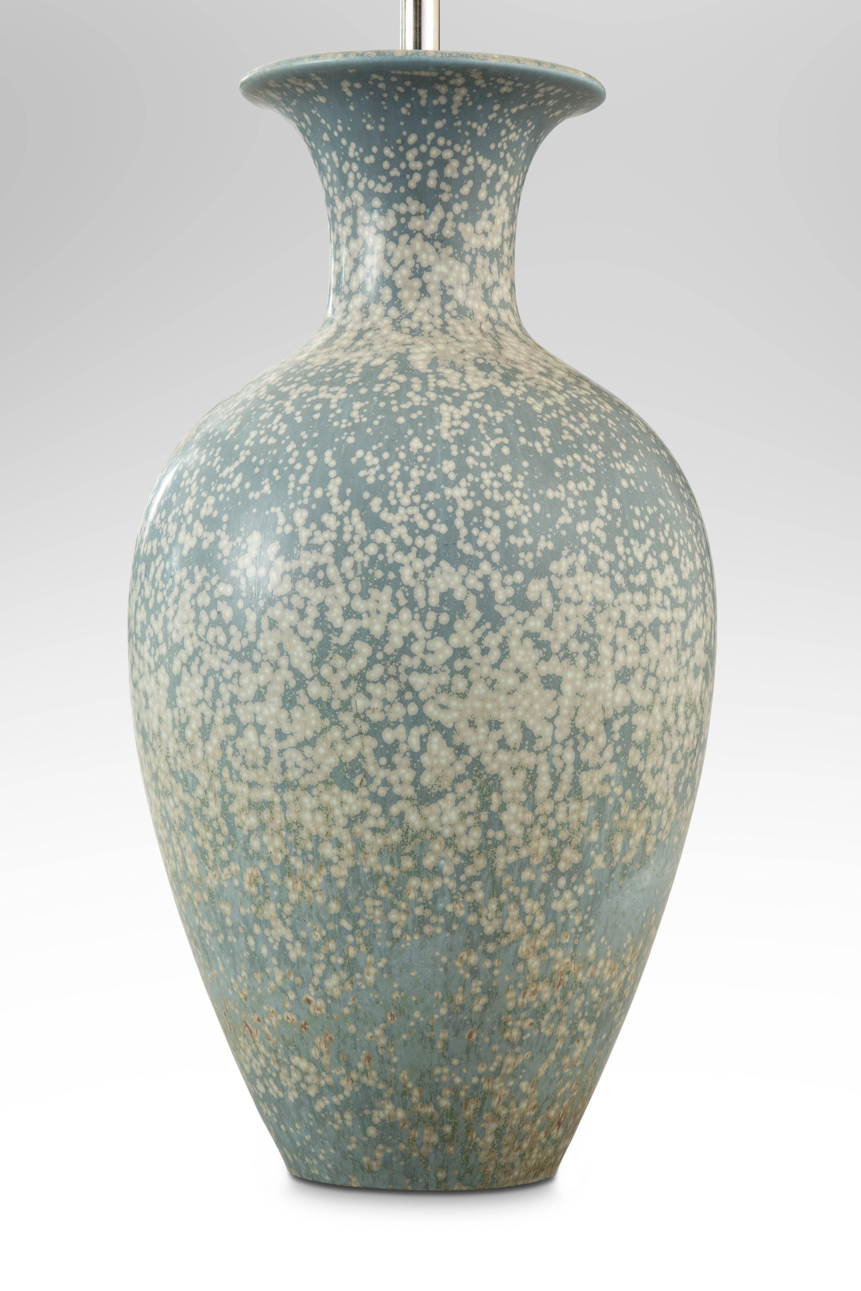A fine example of Nylund's subtle use of variegated white and robins-egg blue glaze. The flared neck above an elegant ovoid body.

Very good condition and ready to add to your collection. Museum wired, not drilled, lamp can easily be converted back