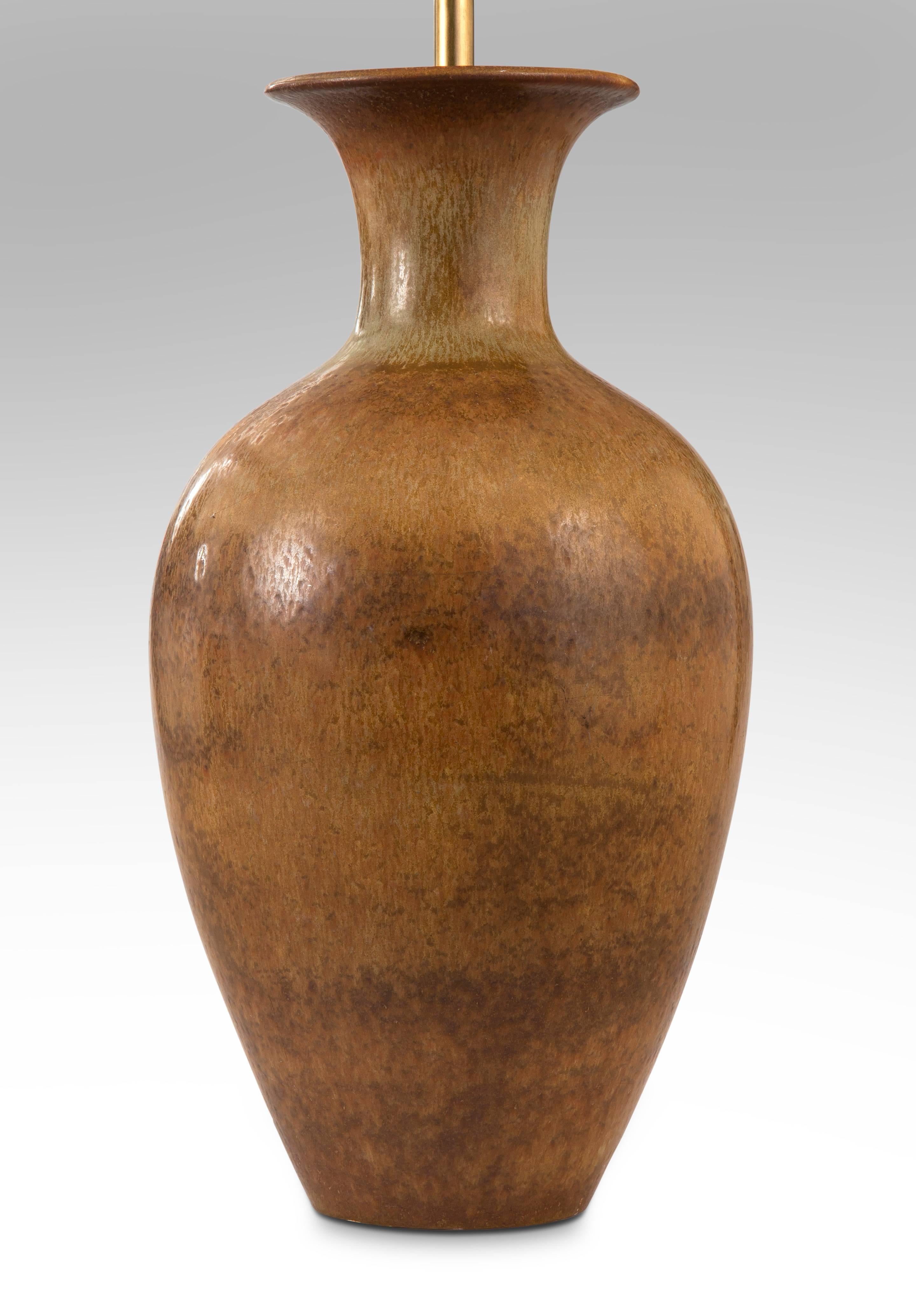 The flared neck above an elegant, high shouldered ovoid body, with a subtly variegated brown glaze. 

Very good condition and ready to add to your collection. Museum wired, not drilled, lamp can easily be converted back into a vase. 