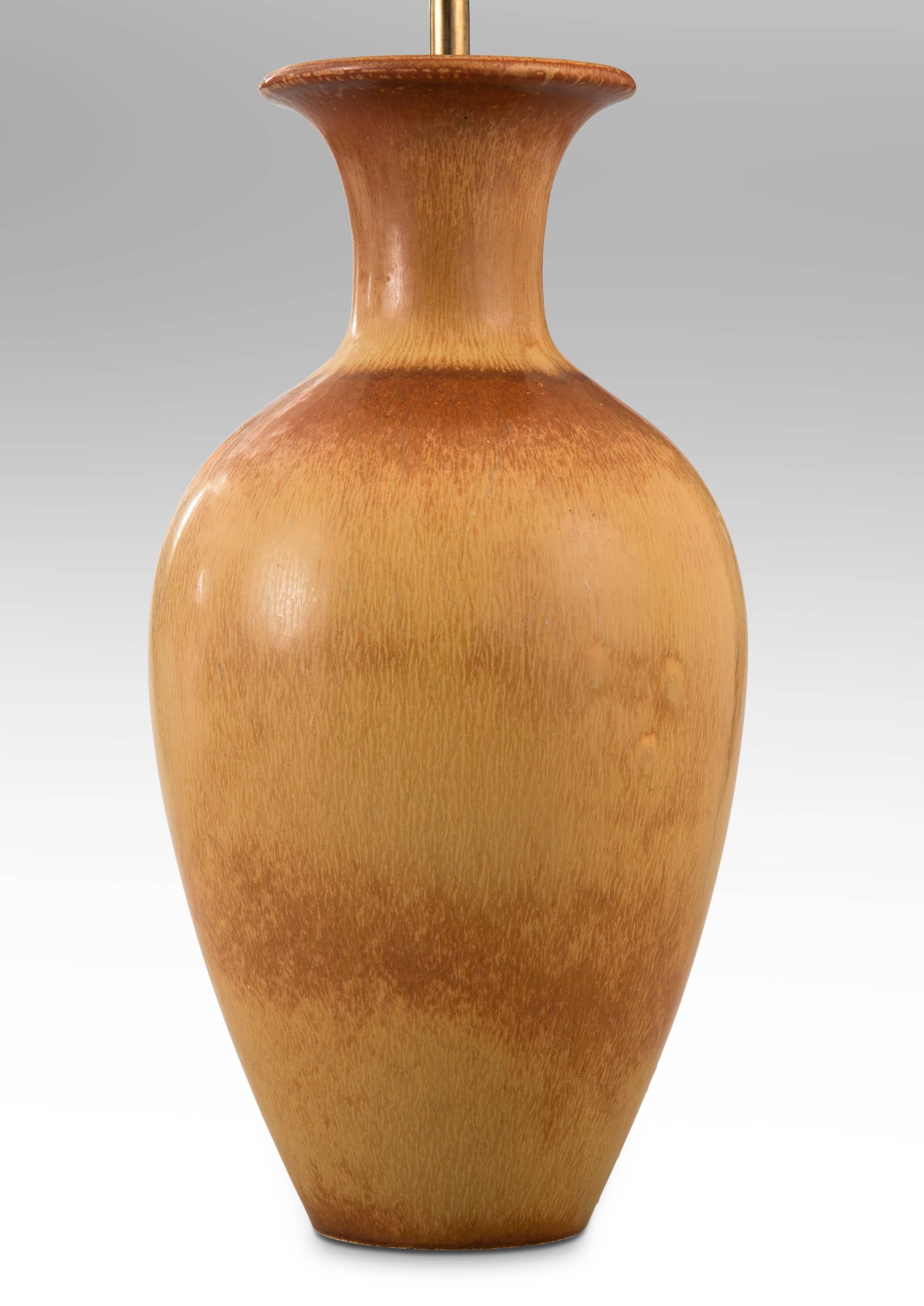 The flared neck above an elegant, high shouldered ovoid body, with a tan and richly variegated brown glaze. 

Very good condition and ready to add to your collection. Museum wired, not drilled, lamp can easily be converted back into a vase. 