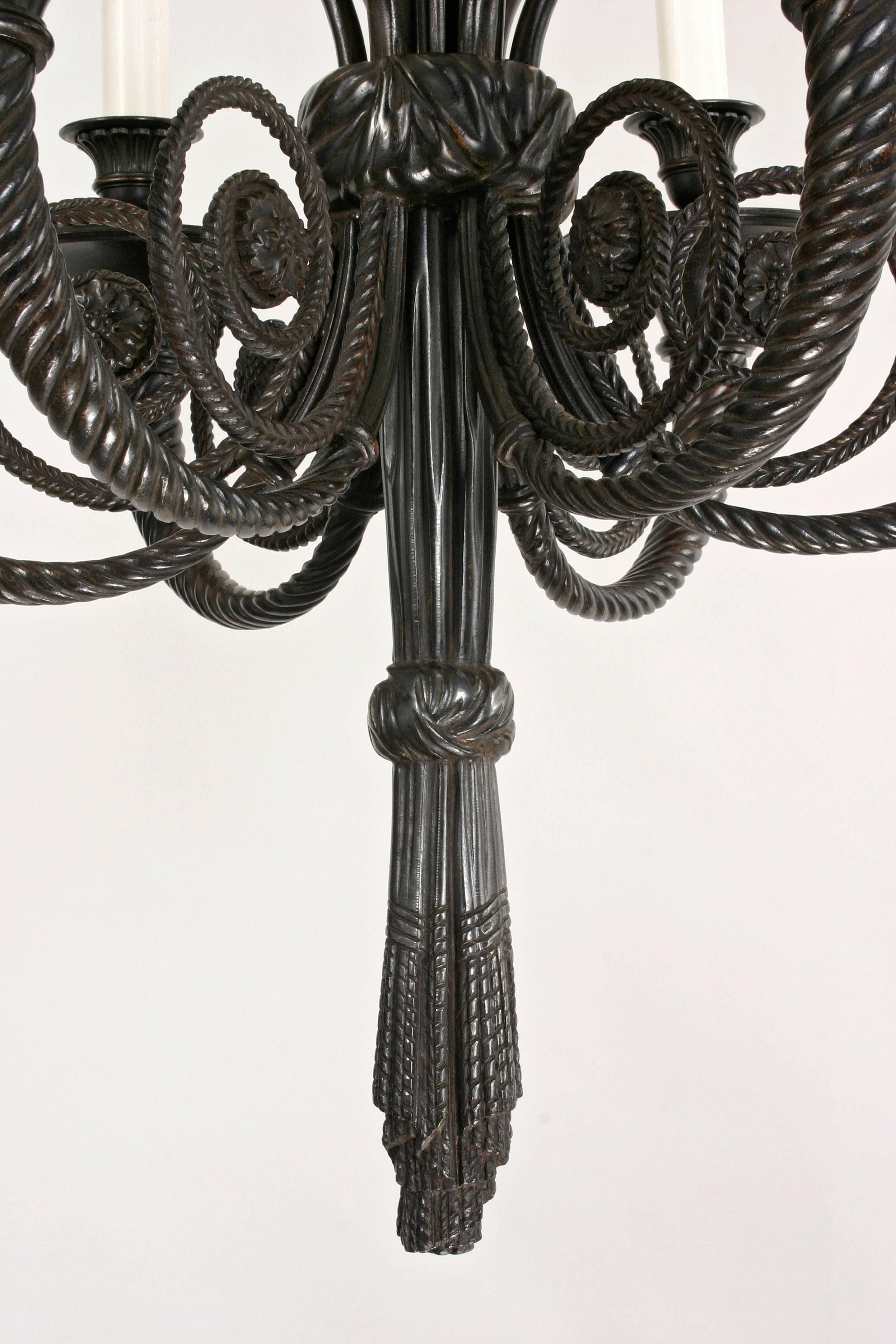 A beautifully designed and well cast bronze chandelier with a elegant patina. The tied ribbon cornona above a swag drapery stem issuing six spiraled trumpet-form arms, terminating with a tied drapery finial. 

In great condition, a good looking