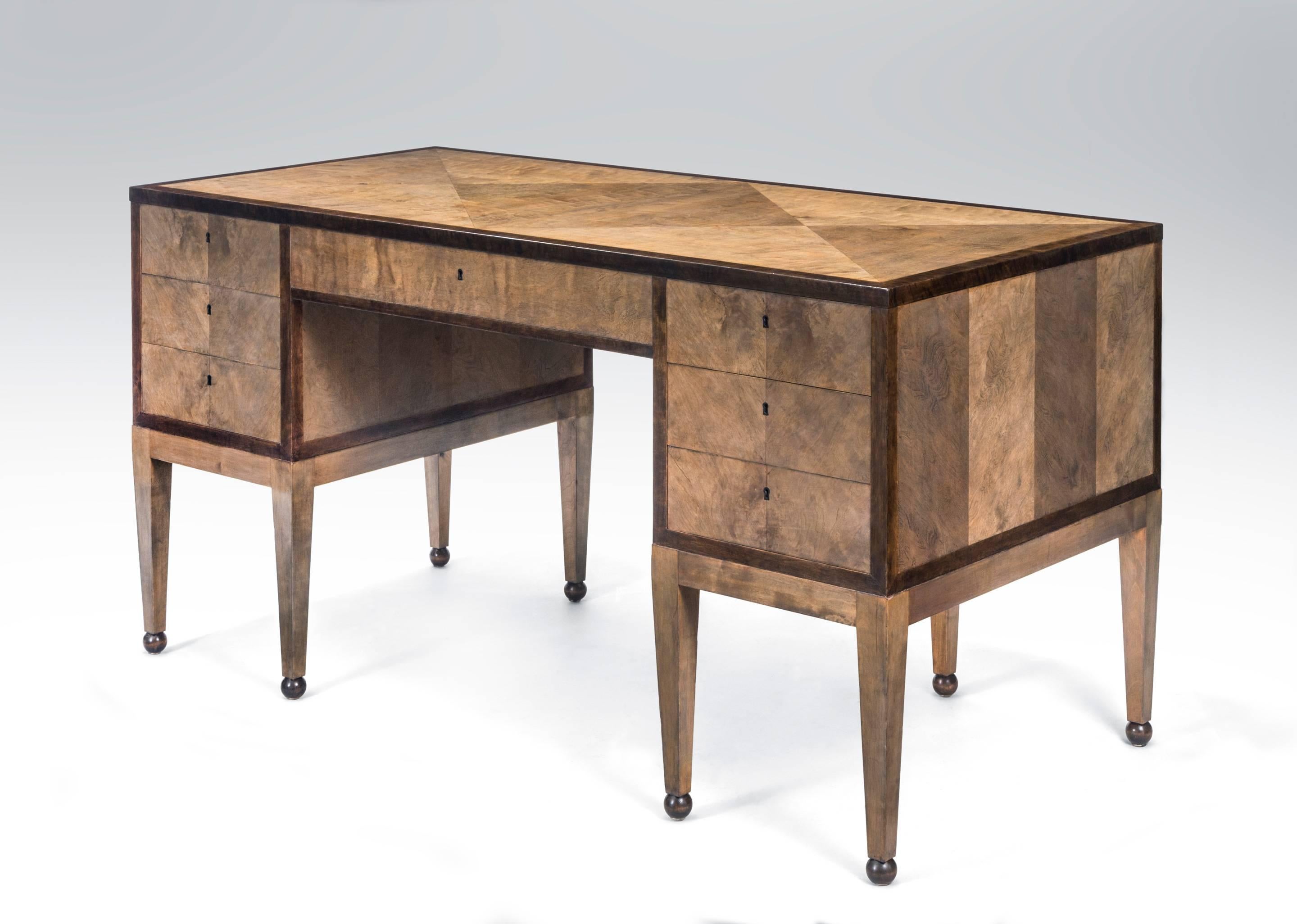A Carl Malmsten attributed Swedish Grace Period  Birch Pedestal Desk, circa 1930.
A very useful and nicely proportioned 7 drawer desk composed of attractive gray stained birch with an elegant   contrasting banding. The rectangular parquetry birch