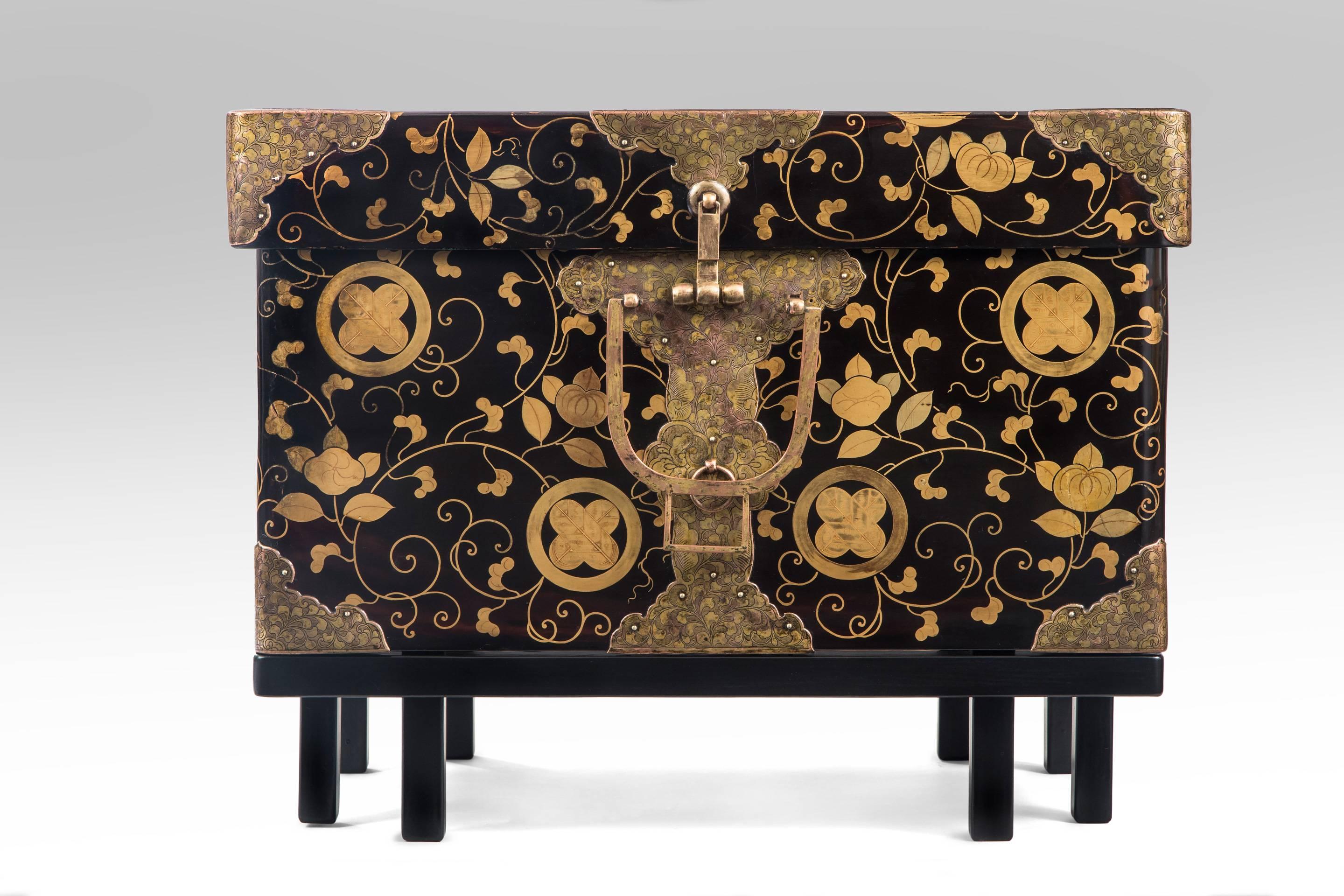 A Japanese Gilt Metal Mounted and Lacquer Hasami-Bako (Robe Chest / Box)
The whole adorned in hawk feather kamons against a trailing vine on black background, the rectangular lid fitted to a conforming base, the gilt mounts engraved scrolling vines,
