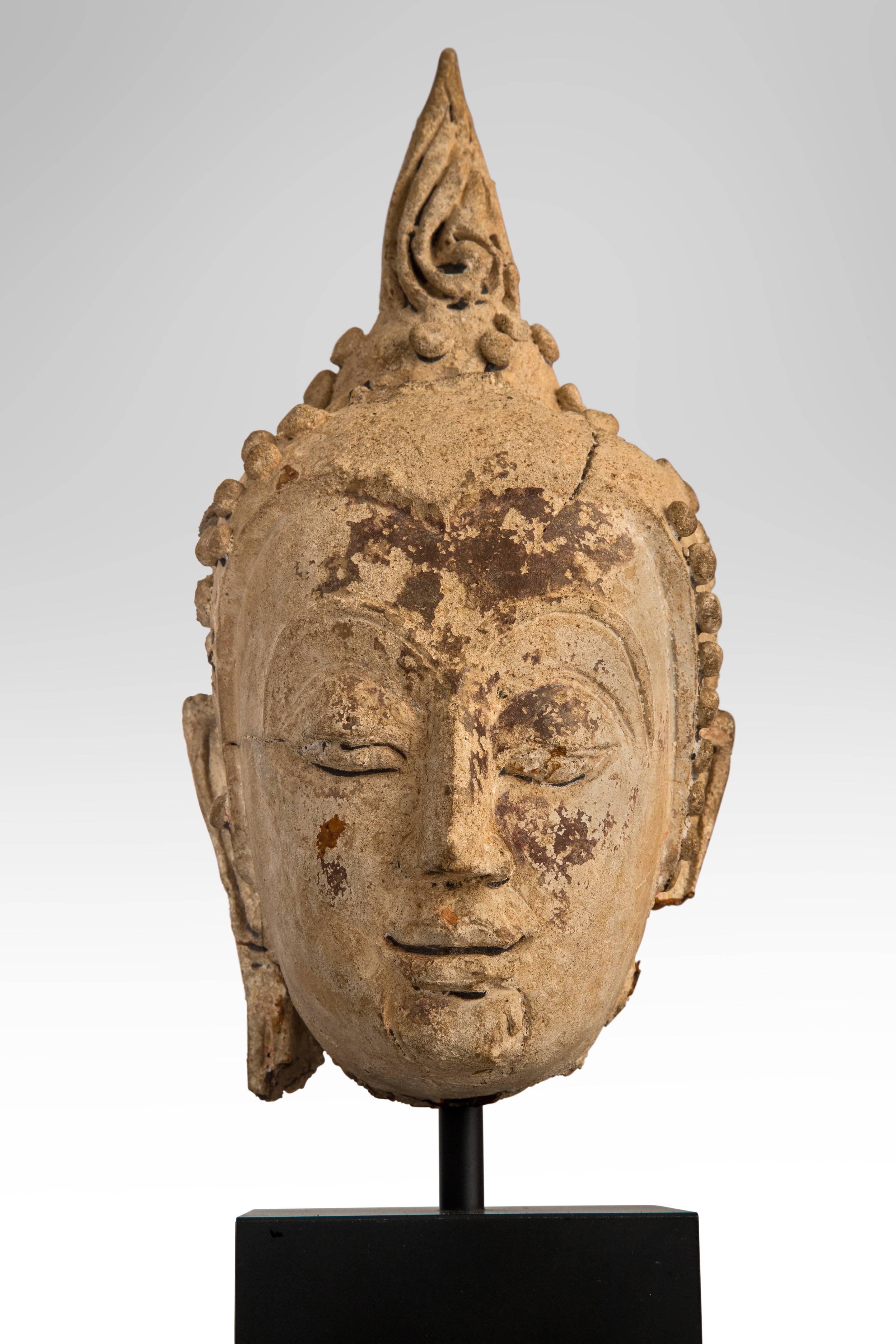 An Ayunthia period Thai Buddha bust
The bust with Ketumala intact on a later stand, presumably once painted.
16th century or later.