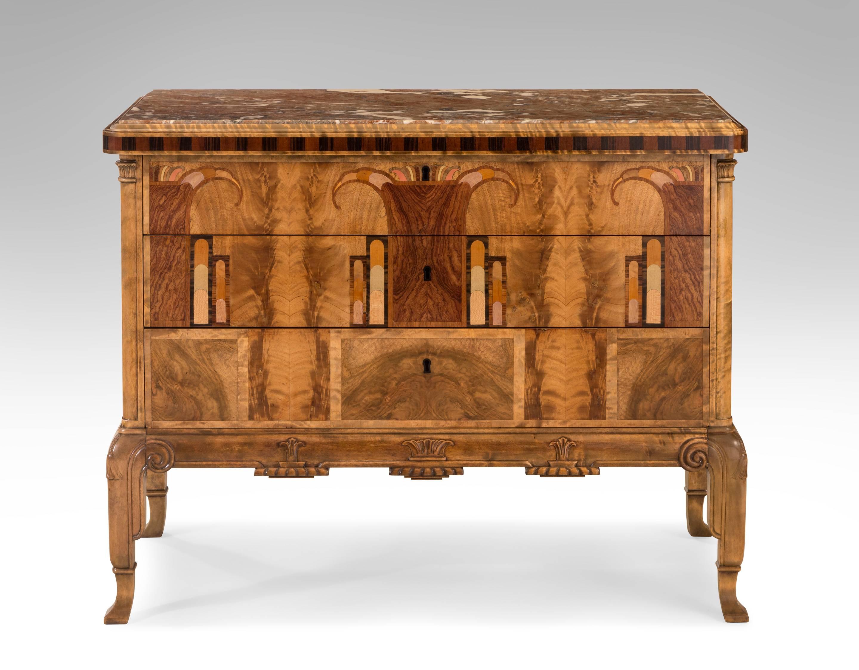 The marble top inset within a molded border, above a marquetry frieze adorned with stylized triglyphs, with two carved pilasters flanking three drawers embellished in a rich marquetry scene, the apron with palmettes, raised on scrolled and tasseled